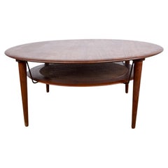 Danish round coffee table in Teak, Brass and Cannage, model FD 515, Peter Hvidt.
