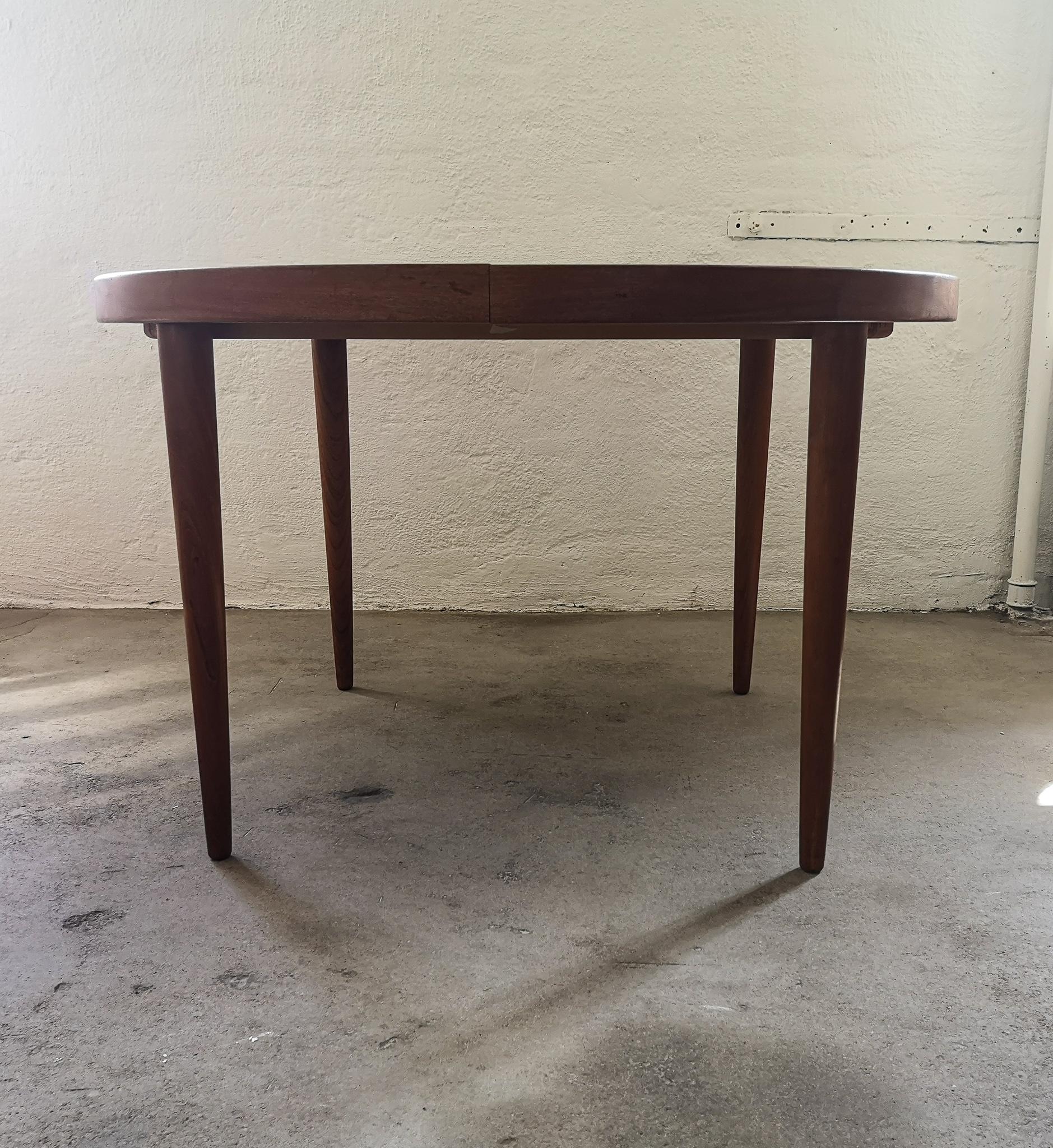 Wonderful dinner table designed by Kai Kristiansen and produced in Denmark, 1960s.
The table comes with two additional 2 extensions, one of them with beautiful rim to give a luxurious look.
It has the deep beautiful look of teak.

Exceptionally