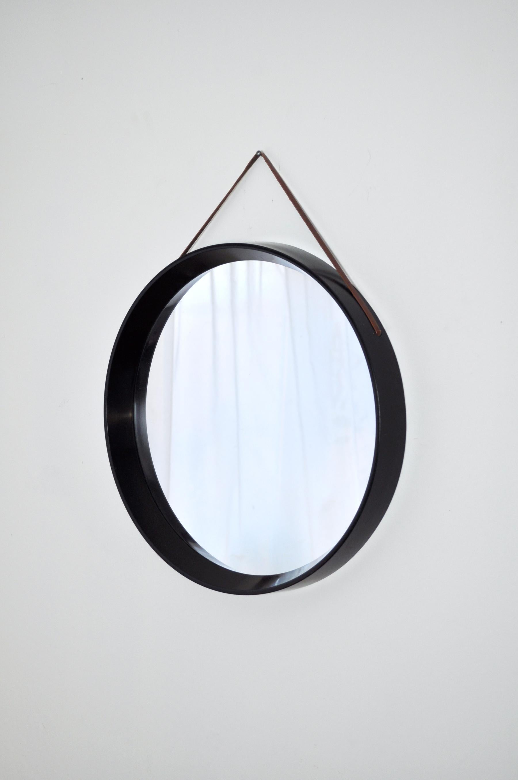 A black Danish round mirror with a thin leather strap, 1980s