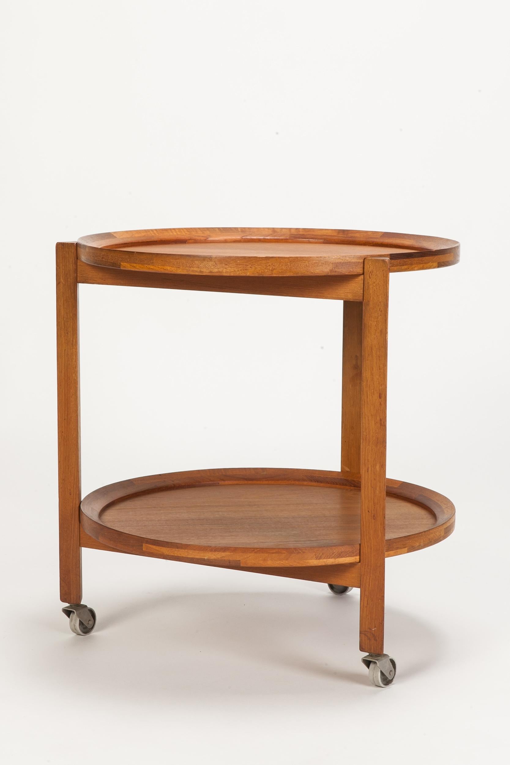 Lovely round teak wood service trolley on wheels. Trays are removable.