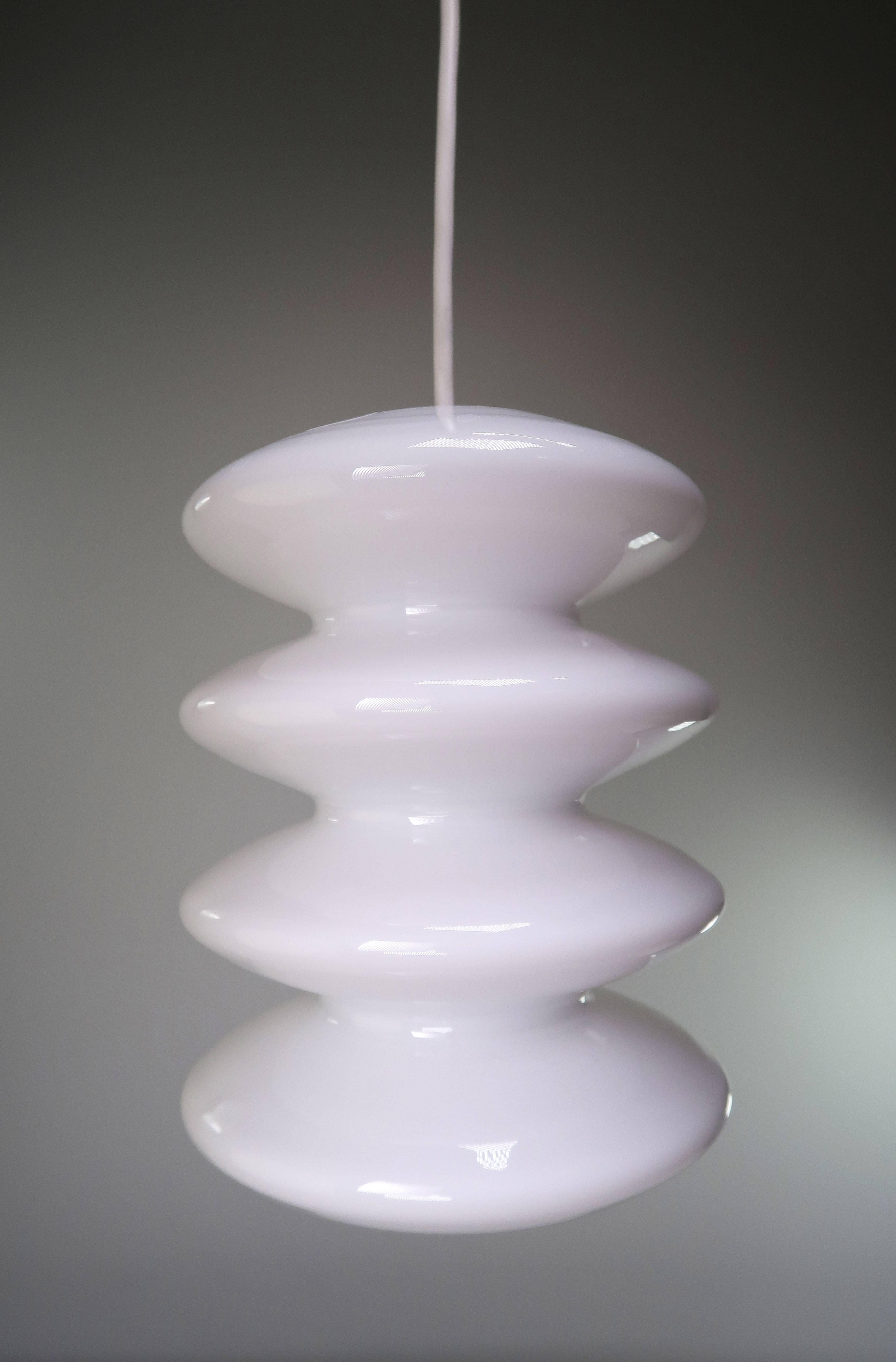 Beautiful Danish mouth blown opaline white glass pendant in mint condition. Luminescent milky white glass making the light shine through beautifully. Designed by Peter Svarrer for Holmegaard in the very beginning of the 21th century. Labelled on