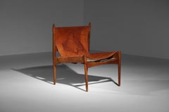 Danish safari armchair in patinated leather and teak from the 60's