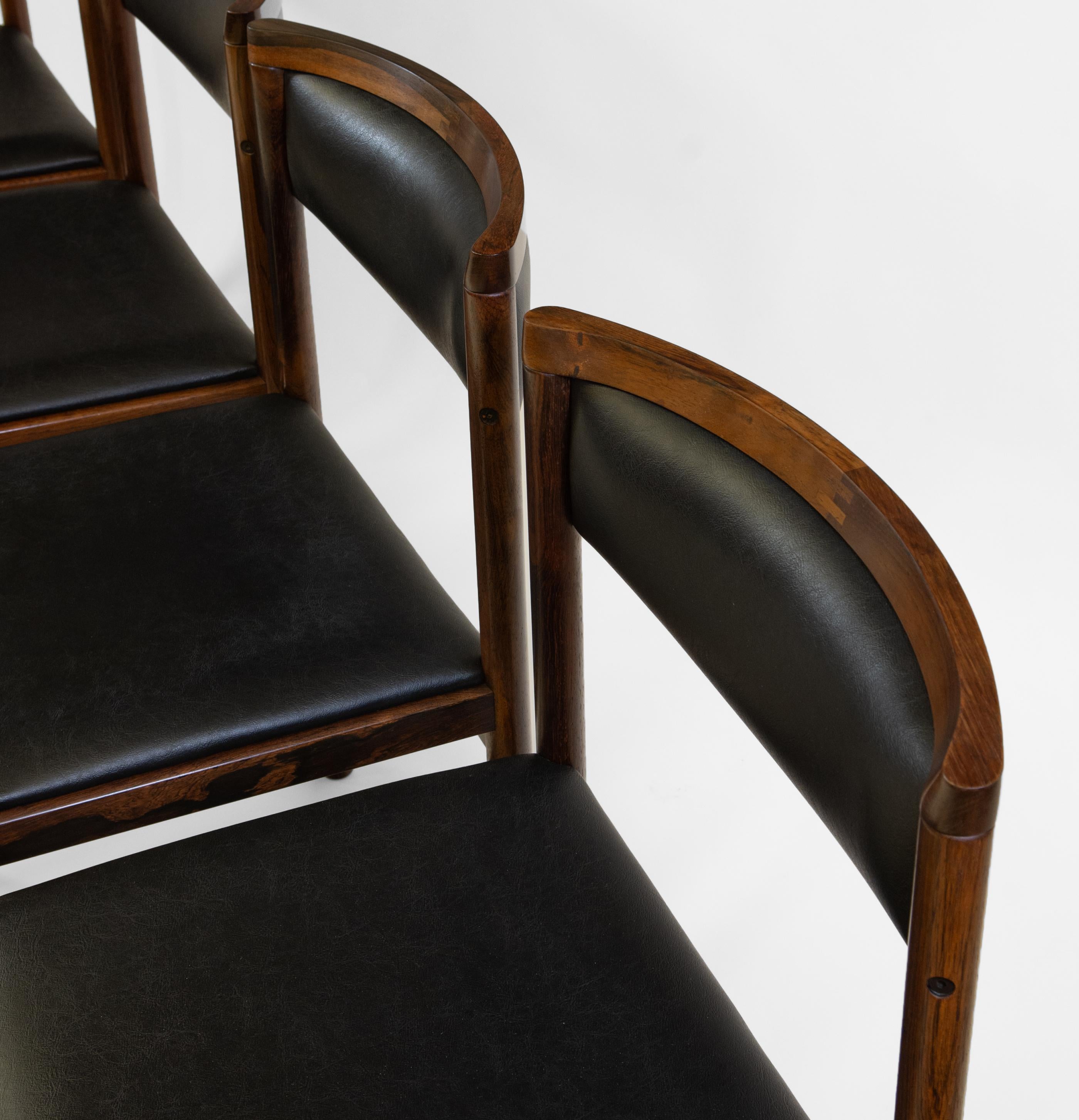 Mid century Danish set of four solid rosewood dining chairs with black textured vinyl seating by Saxkjøbing Savvaerk. Circa 1960. Stamped: SAX Made In Denmark.

Delivery is INCLUDED in the price for all areas in MAINLAND England & Wales. 

*CITES