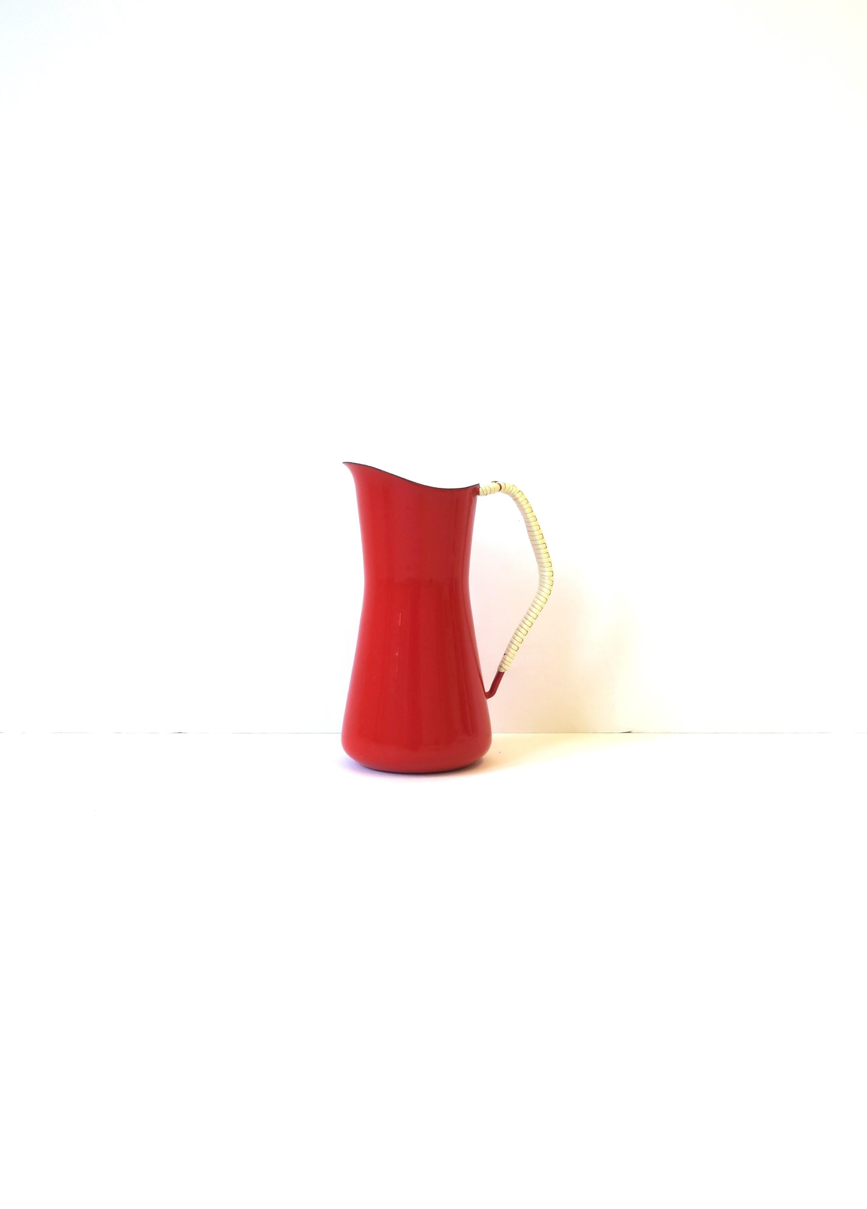 A beautiful vintage Dansk Kobenstyle Danish Scandinavian Modern red enamel and white wicker wrapped handle pitcher, circa mid-20th century, Denmark. Great to use as a pitcher, display as a standalone piece, or as vase with flowers. Makers' mark and