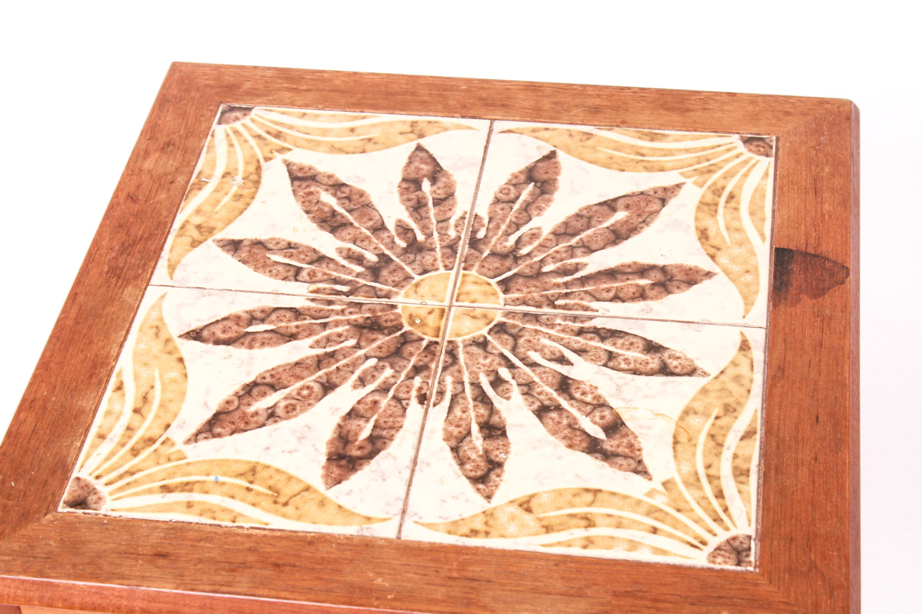 Danish Scandinavian Modern square side table with a decorative inset tiled top with geometric motif. The piece has a 