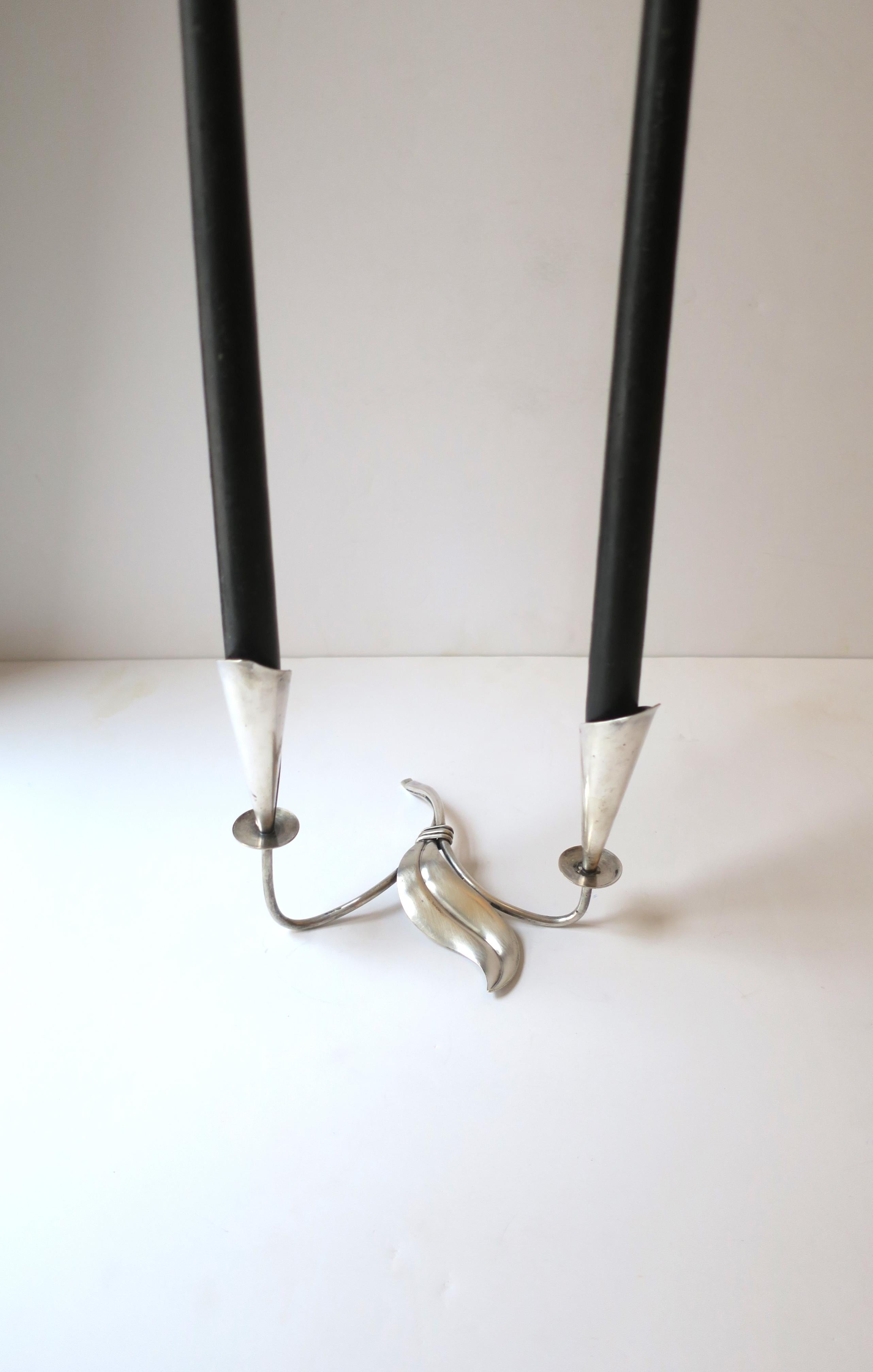 A beautiful Danish / Scandinavian Modern / Organic Modern sterling silver plate candlestick or candelabra holder attributed to designer Hans Jensen, circa mid-20th century, Denmark. Holder has two stems with modern Calla Lilly flower sconces, small