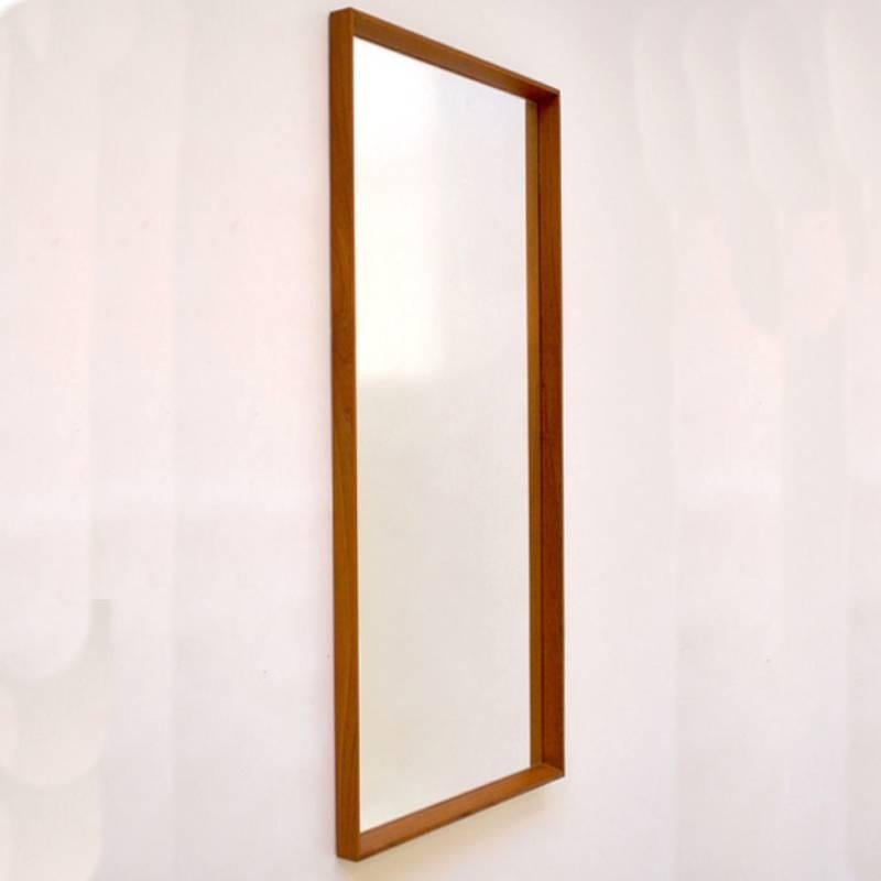 Nice sized rectangular solid beveled teak framed mirror with maker's mark on back. Marked made in Denmark by AM or MM Spejle. Measures: 46