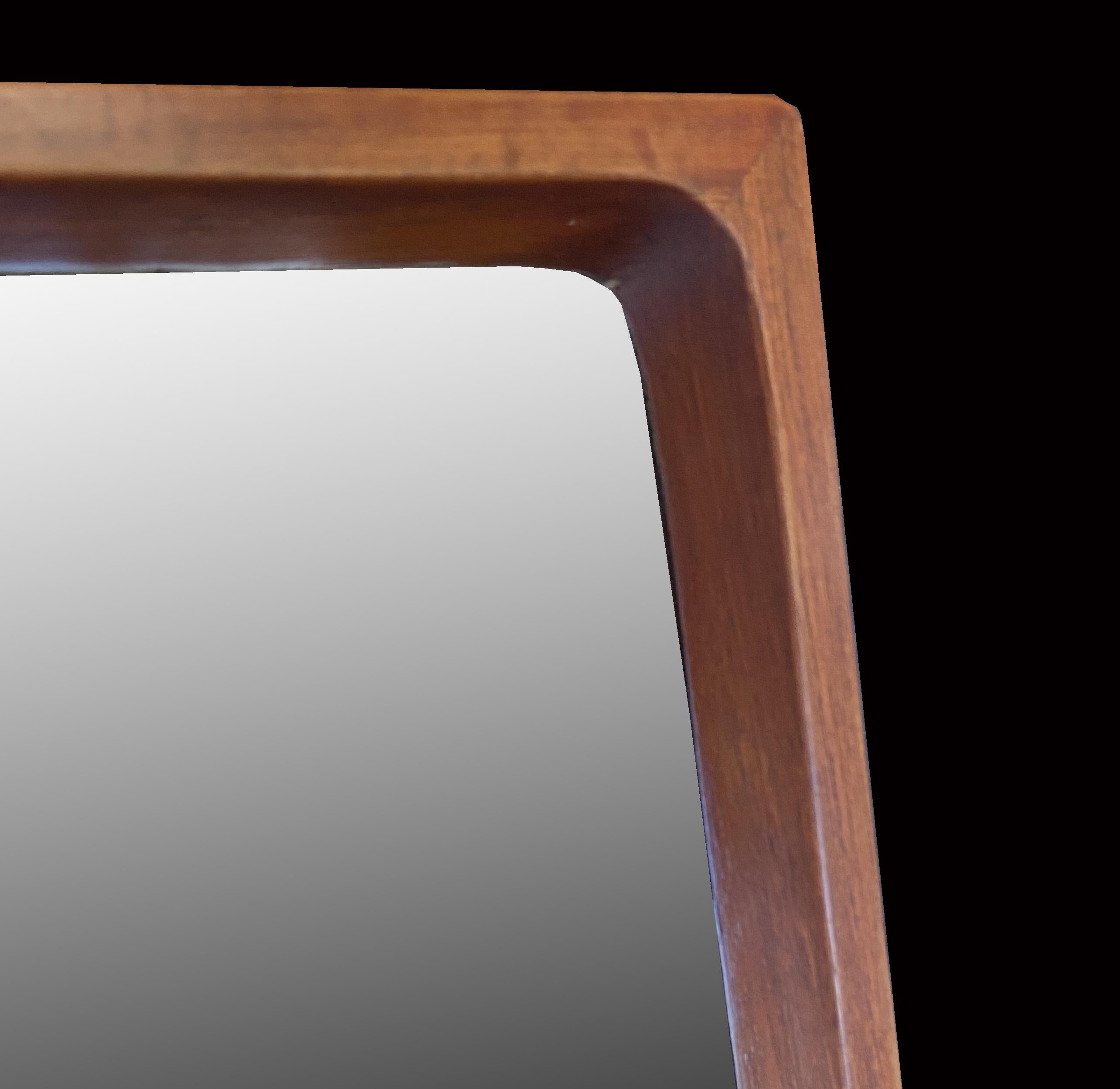 A Classic Scandinavian Modern teak wall mirror in good original condition and ready to hand on any wall.