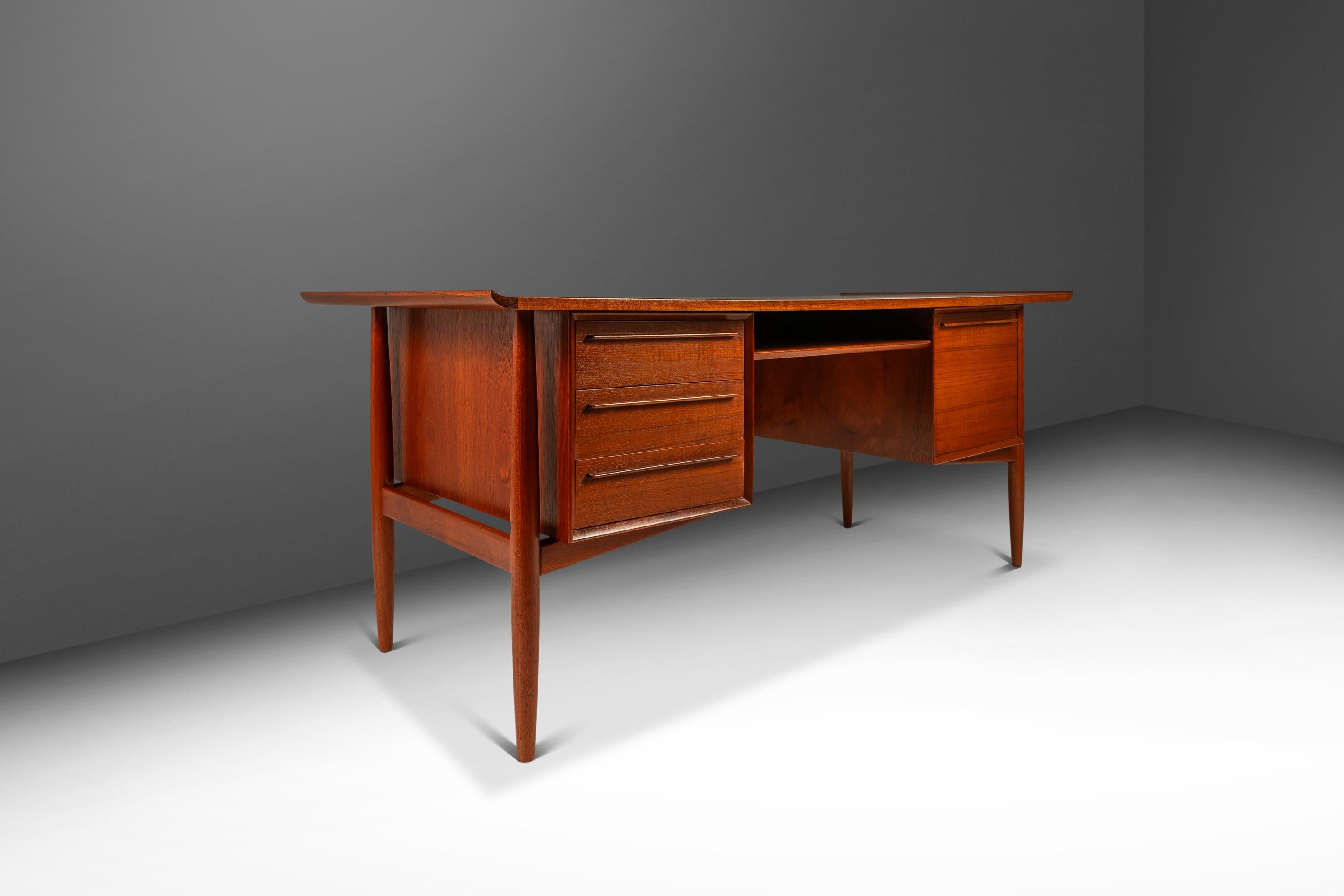 This exquisite Danish-made executive desk, designed by the influential Arne Vodder for the lauded H.P. Hansen Furniture Co, has recently undergone a comprehensive restoration process. The stance of this desk is absolute perfection in every way, from