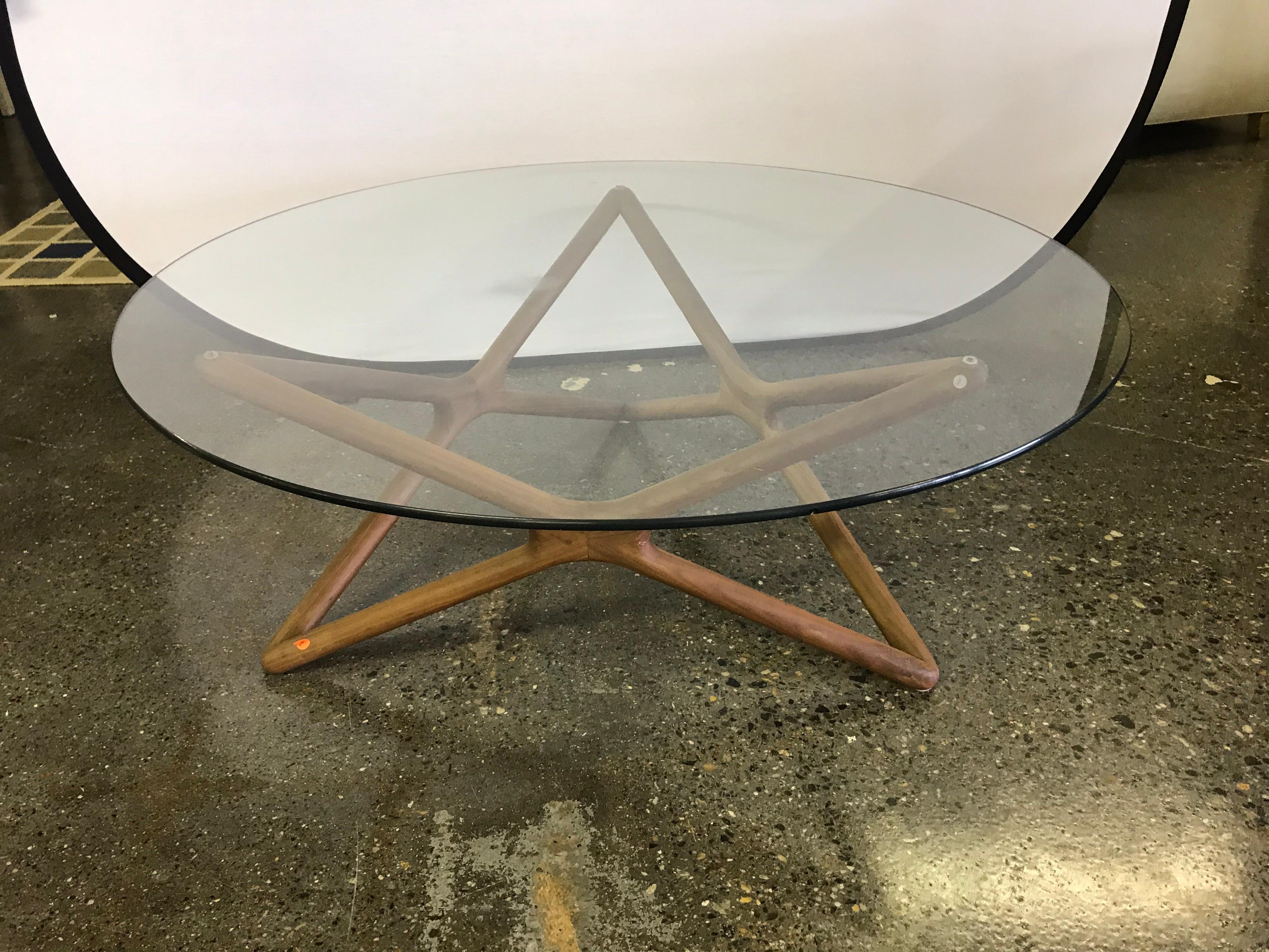 Elegant and timeless Danish modern round coffee table with teak base and removable glass top.