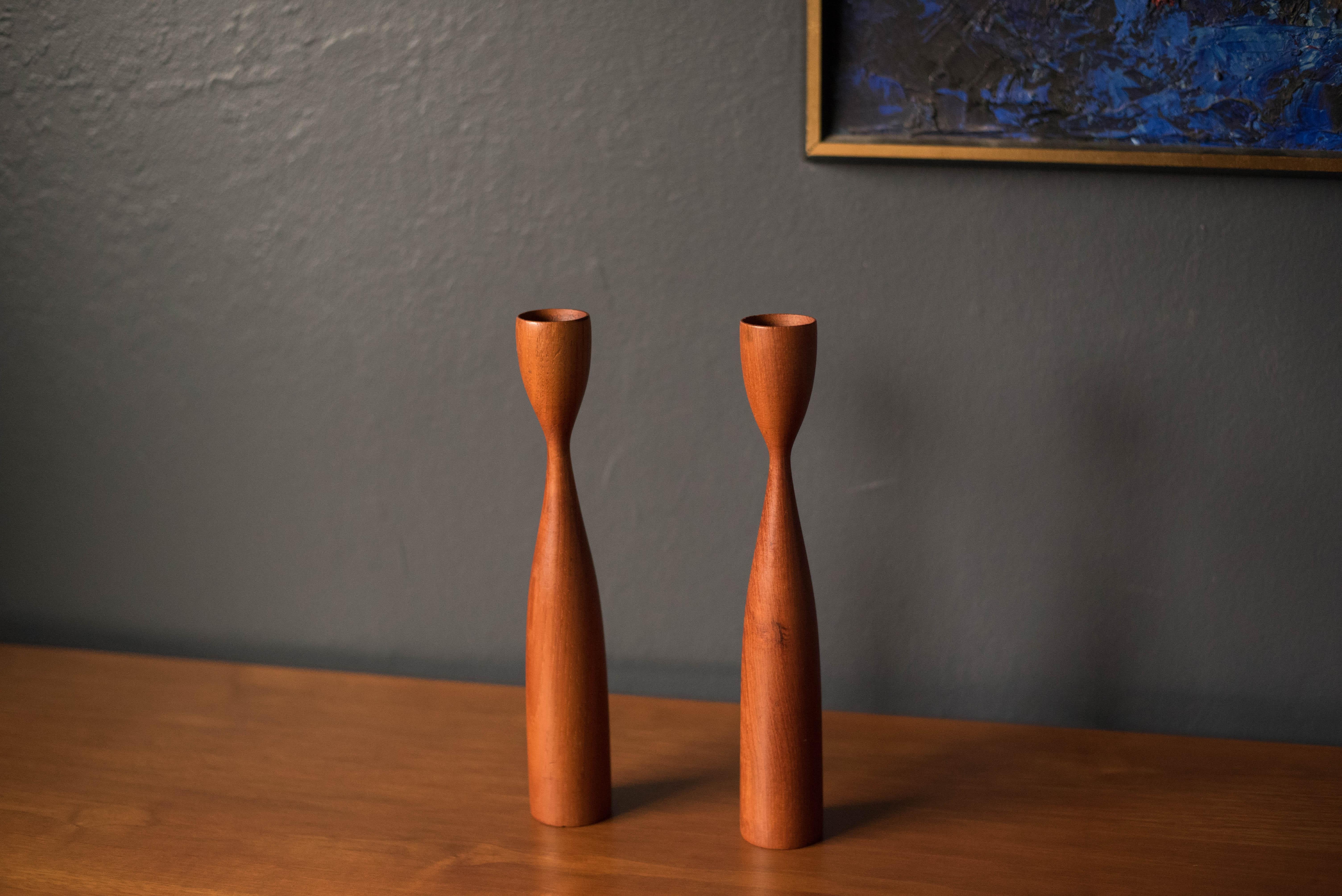 Vintage pair of teak candle holders made in Denmark. This set displays well with any modern decor and fits 3/4