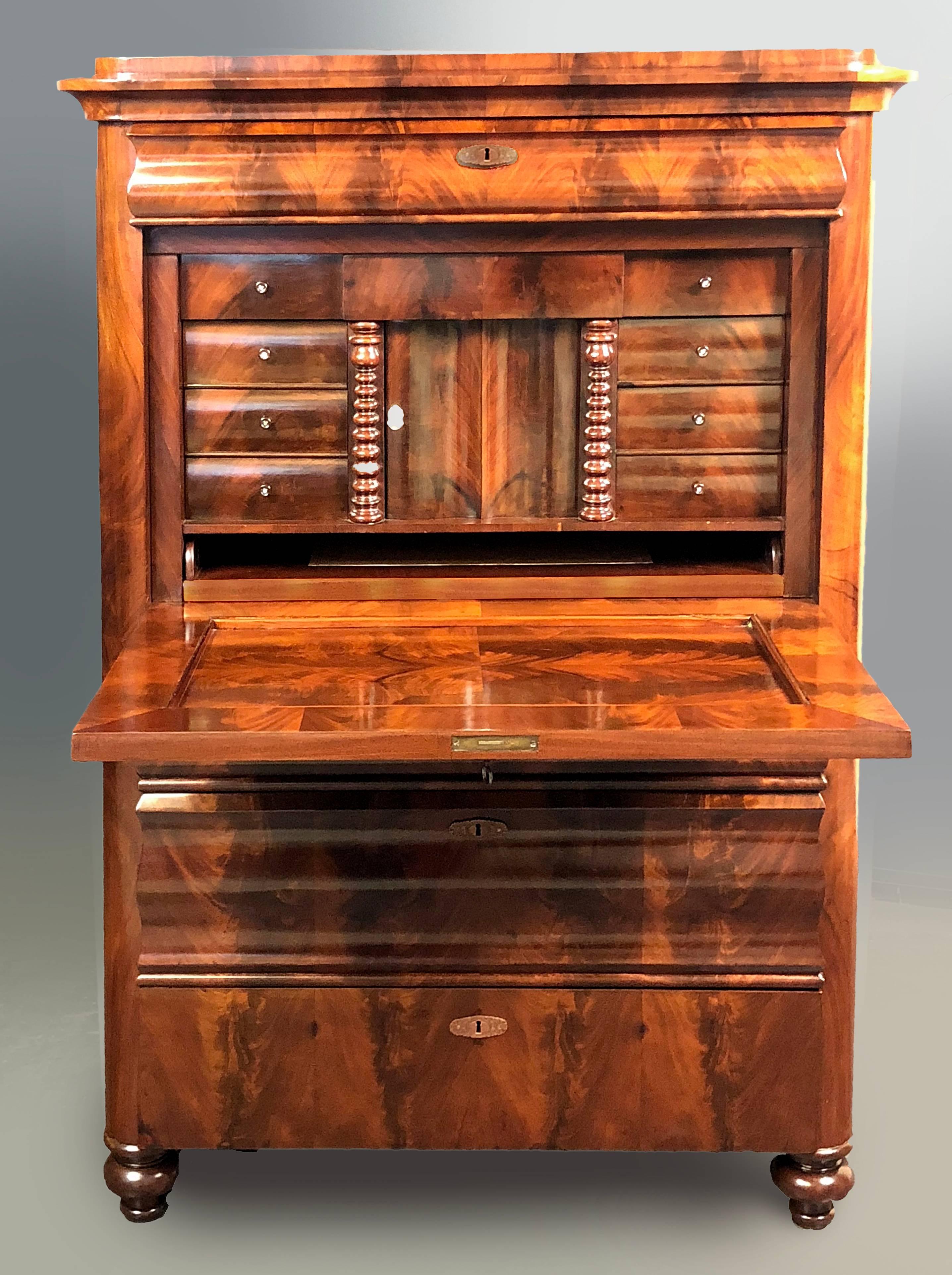 Fine figured mahogany Secretaire a Abattant of Danish origin dating to the middle of the 19th century, exhibiting Louis Philippe influence. The fall front has interior weights and the writing surface slides outward and features a gold tooled leather