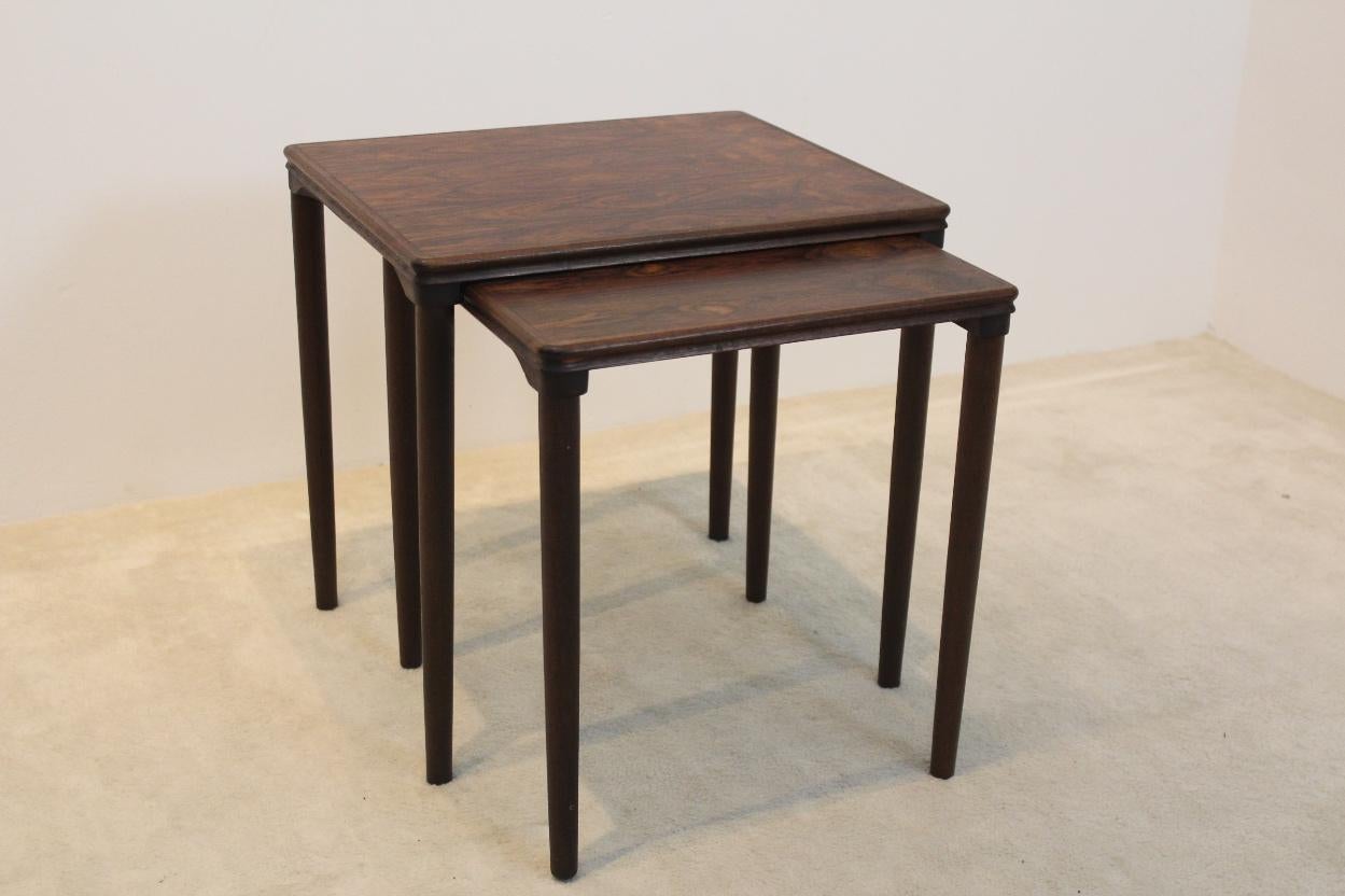 Beautiful set of two nesting tables designed by E. W. Bach and manufactured in the 1960s by Møbelfabrikken Toften in Denmark. Very nice dark Oak frame with beautiful wood grain structure. They are in excellent vintage condition.