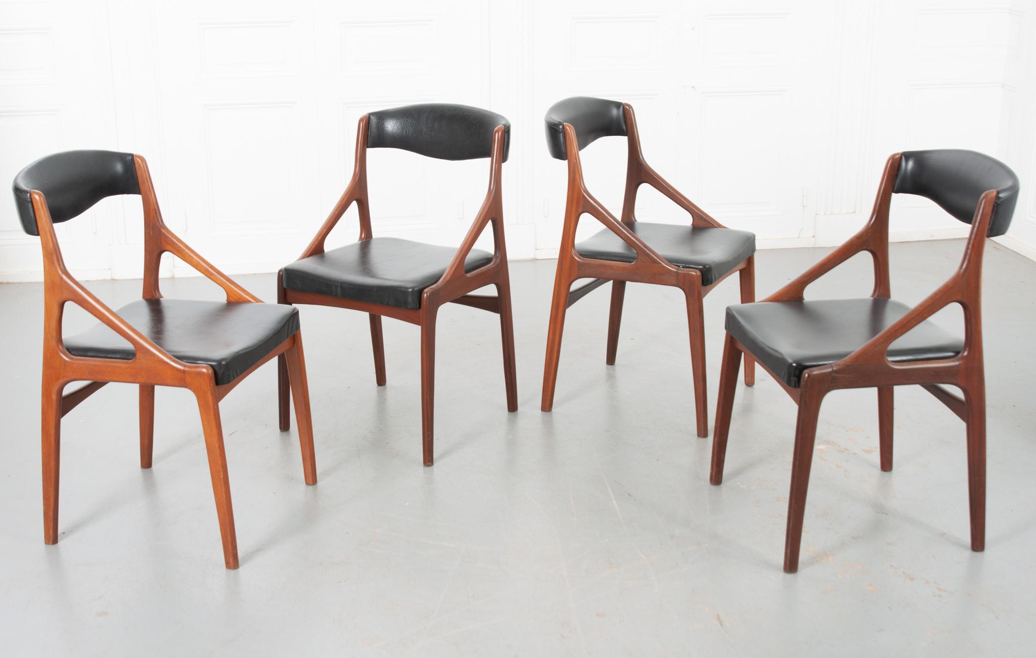 Sold as a set of four, these mid-century Danish dining chairs are sleek and easy to incorporate into your current decor. The smooth, light toned wood contrasts nicely with the black vinyl leather cushions. Seat height is 17-¼”. Make sure to view the