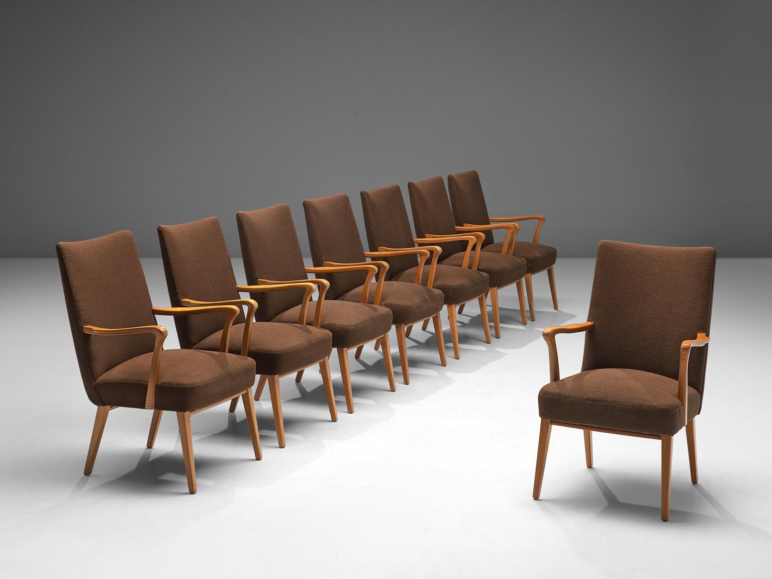 Set of eight armchairs, fabric, stained beech, metal, Denmark, 1960s

This Danish set of dining chairs features an elegant profile with curved lines and sleek shapes dominating the layout. The organically shaped armrests and the tapered feet enhance