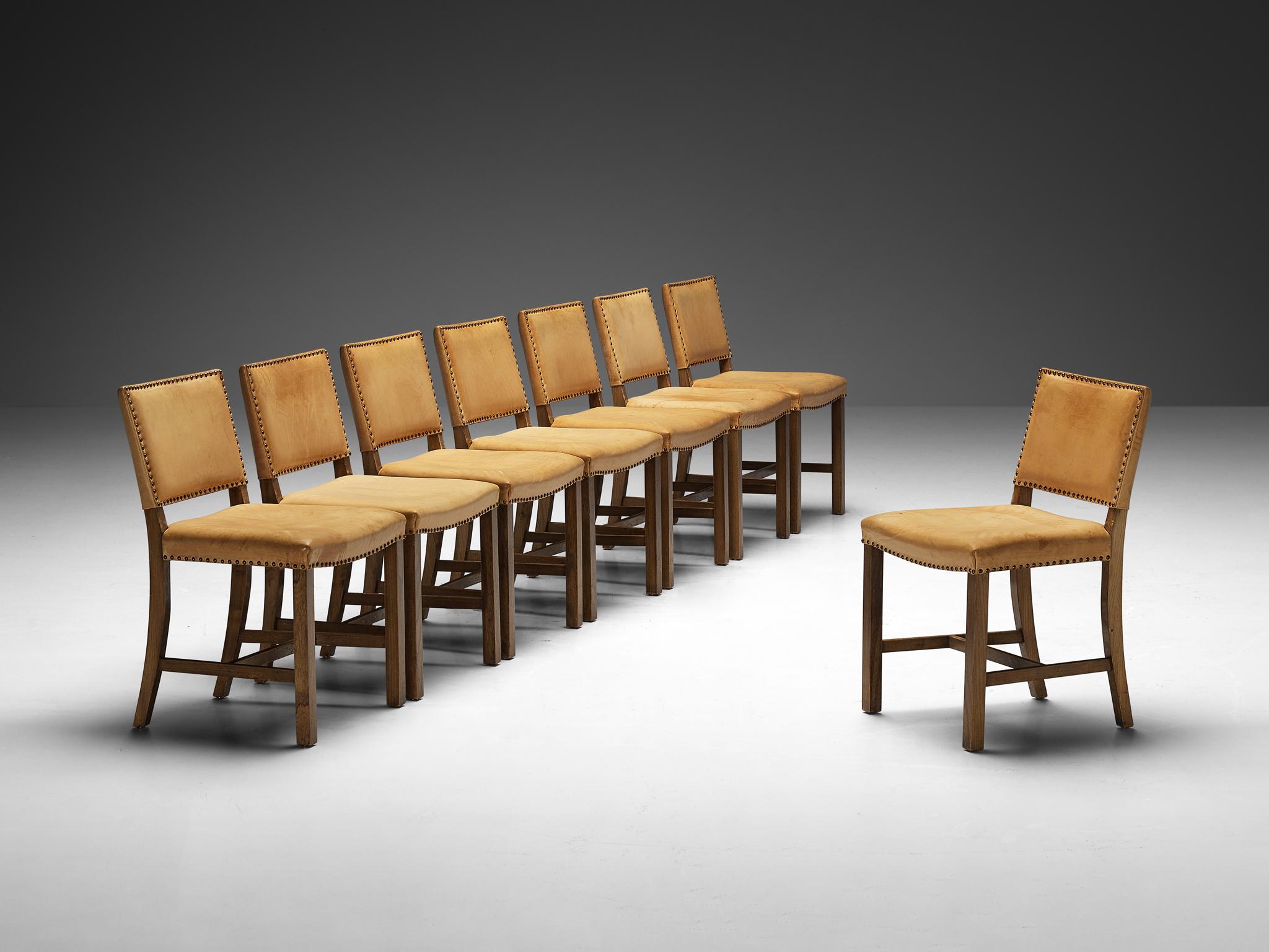 Set of eight dining chairs, elm, leather, metal, Denmark, 1950s

Imbued with timeless elegance and craftsmanship, this set of Danish dining chairs shows strong similarities to the distinguished style of Kaare Klint. Crafted with meticulous attention