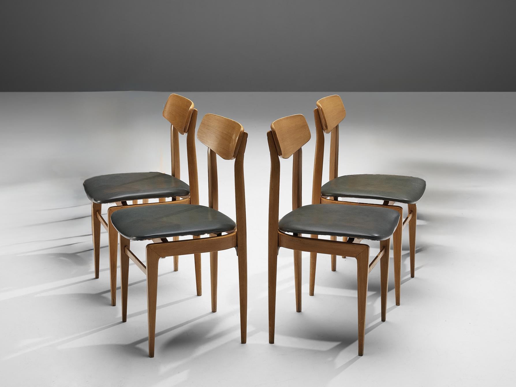 Set of four dining chairs, beech, leatherette, Denmark, 1960s 

Highly elegant chairs that would appear gracefully around one's dining or conference table. The sharp sculpted backrest is supported by two pillar legs that develop to the bottom in a