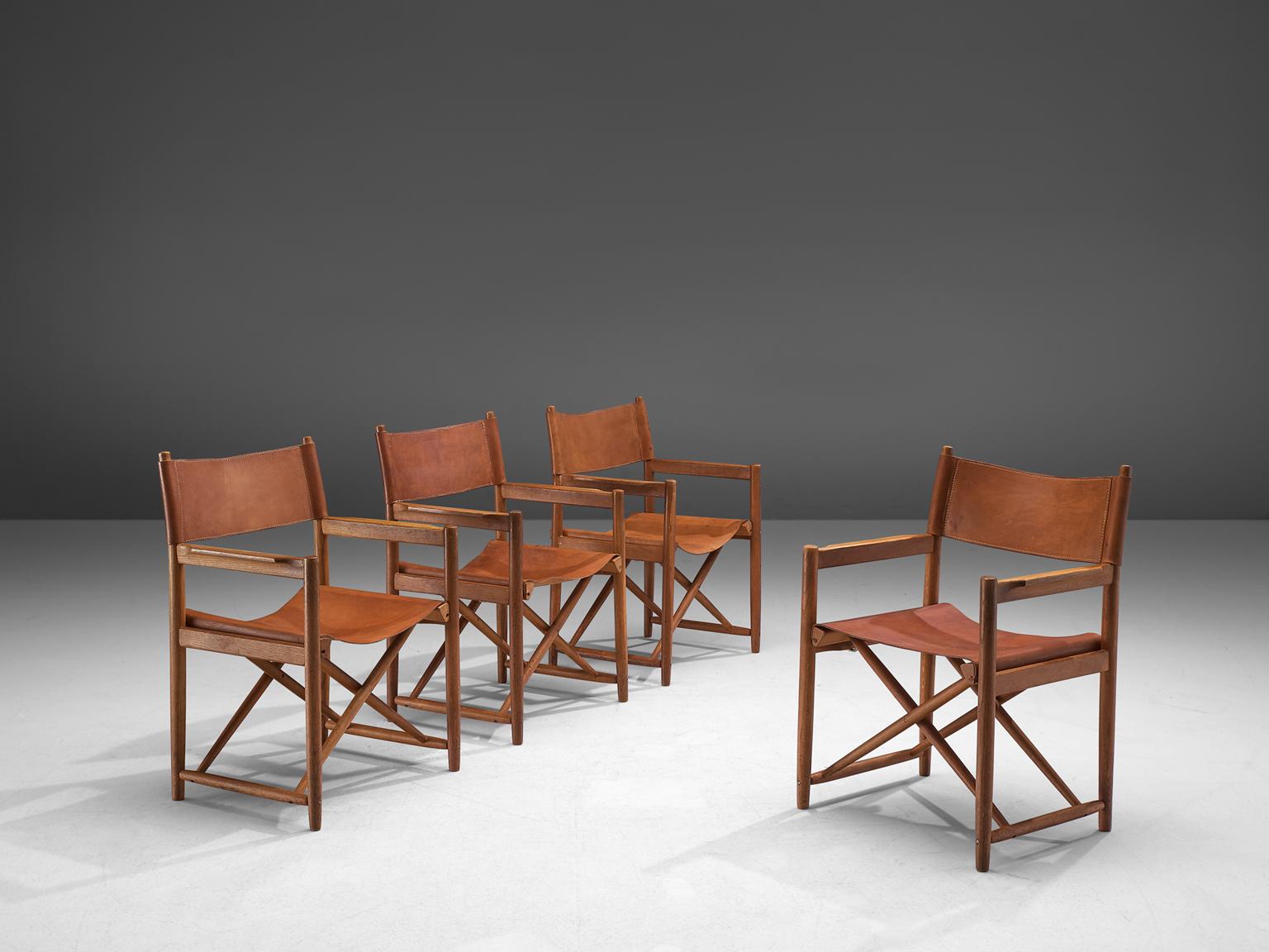 Set of 4 safari chairs, leather and oak, Denmark, 1960s

These elegant safari chairs feature wonderful patinated leather on both the seat and back. The patina on these chairs create a vibrant look. Thanks to the inventive design, the chairs are