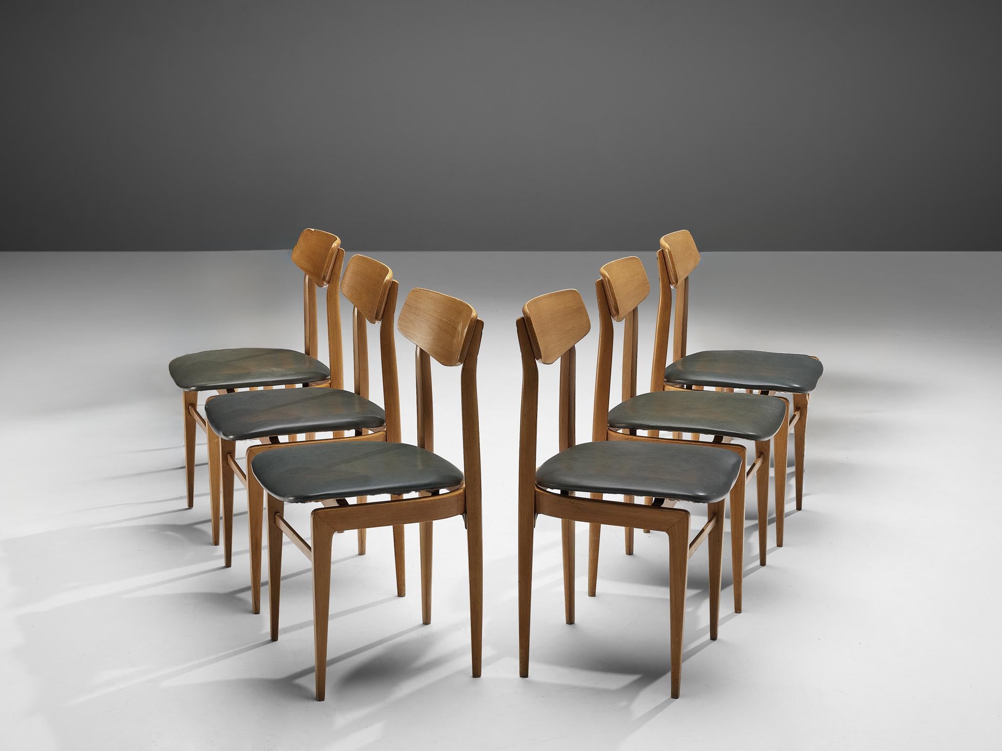 Set of six dining chairs, beech, leatherette, Denmark, 1960s 

Highly elegant chairs that would appear gracefully around one's dining or conference table. The sharp sculpted backrest is supported by two pillar legs that develop to the bottom in a