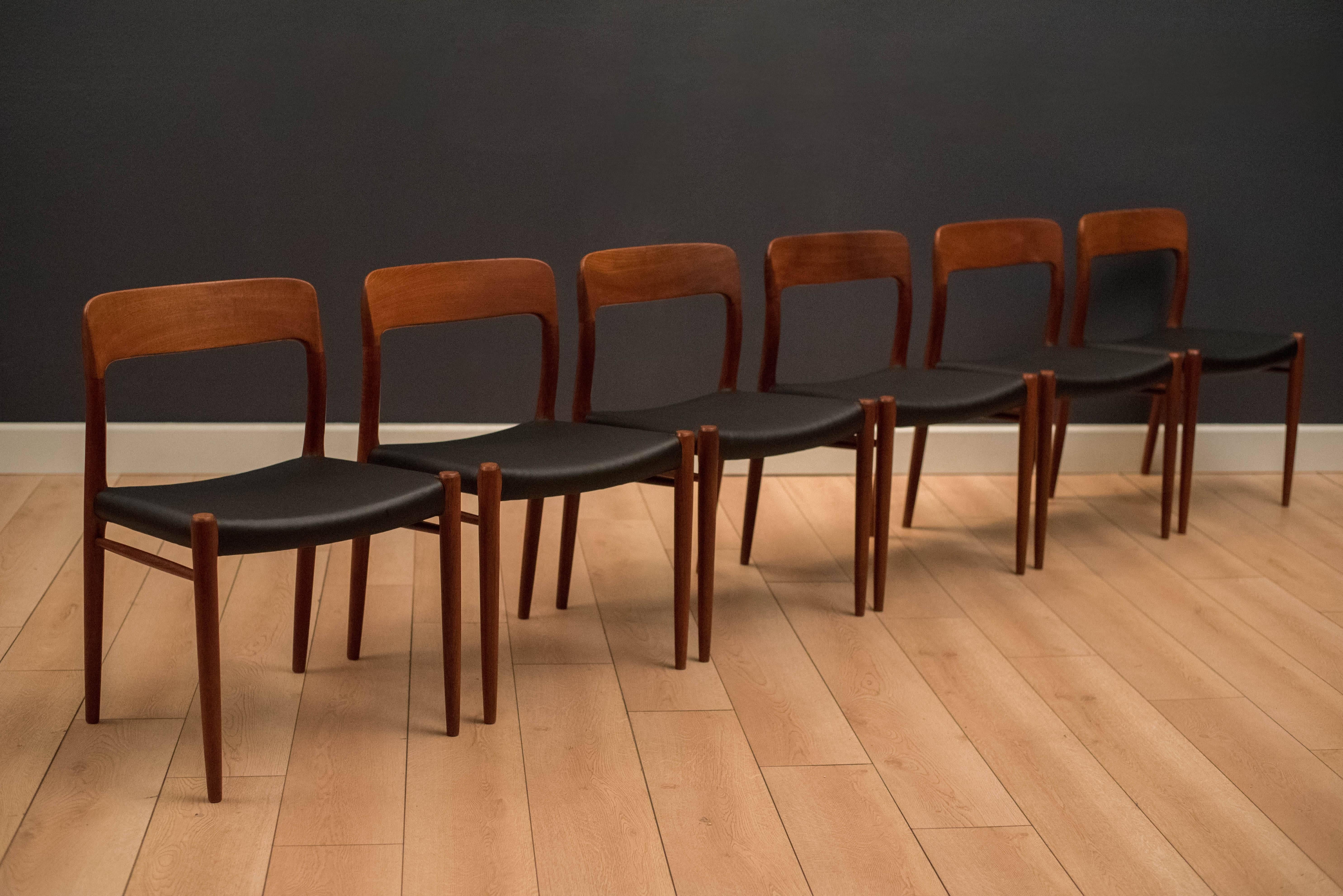 Mid century Niels Moller dining chairs in teak, circa 1960s. This set includes six model no. 75 chairs. Seats have been professionally reupholstered in black leatherette.
 