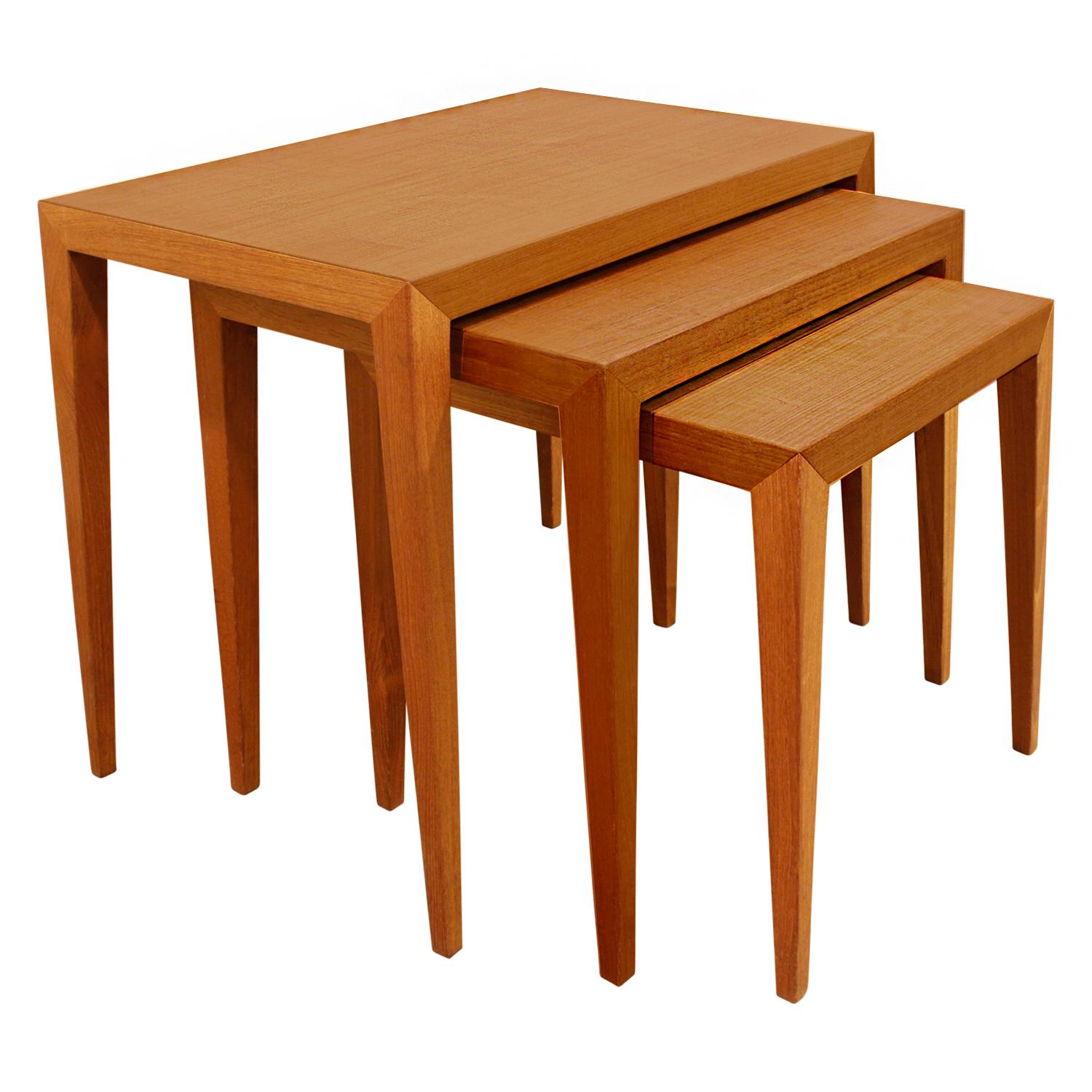 Set of three clean line nesting tables model C-38-6 in teak with tapering legs, Denmark, 1950s (Danish furniture makers control sticker on bottom). These were purchased from the George Tanier showroom in 1966 (original invoice