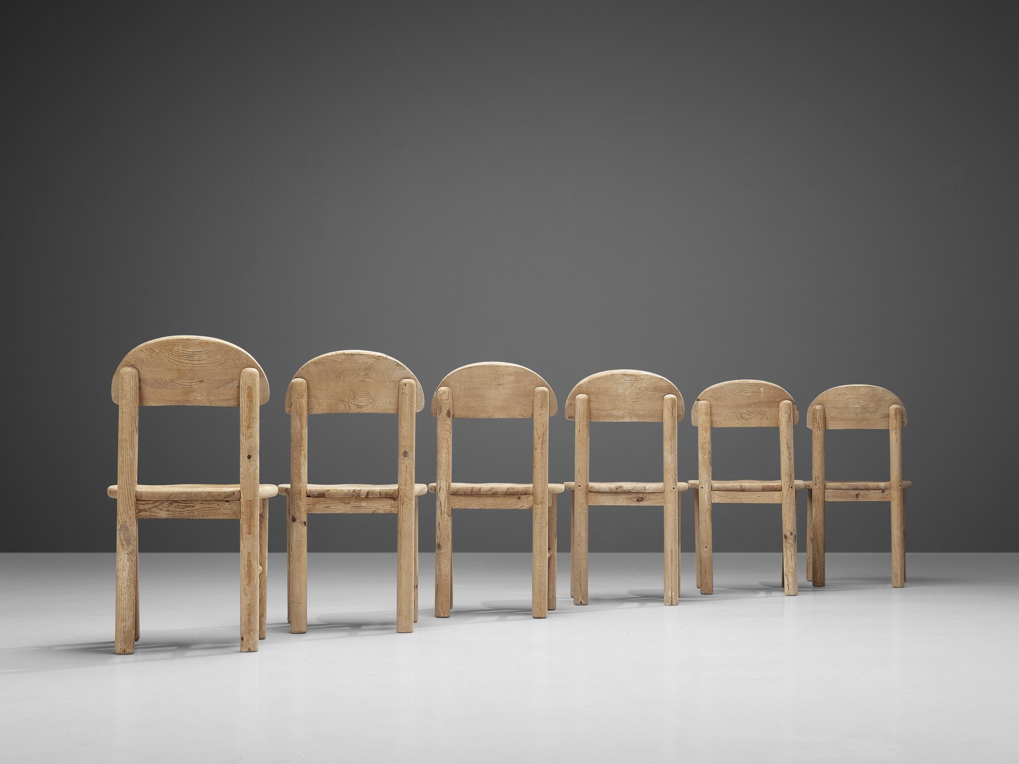 Dining chairs, pine, Denmark, 1970s. 

Large set of six beautiful, organic and natural dining chairs in light stained solid pine. A simplistic design with a round seating and attention for the natural expression and grain of the wood. These chairs