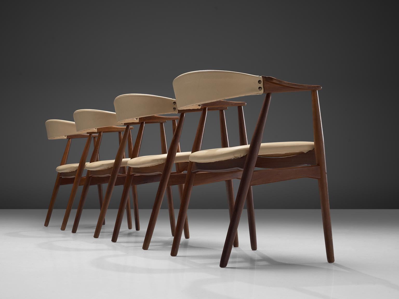 Set of four dining chairs, walnut, brass and leatherette, Denmark, 1960s.

This wonderful set of dining chairs are a great example of Danish midcentury design. The chair is sculptural and made of walnut. The legs are tapered and connected to the