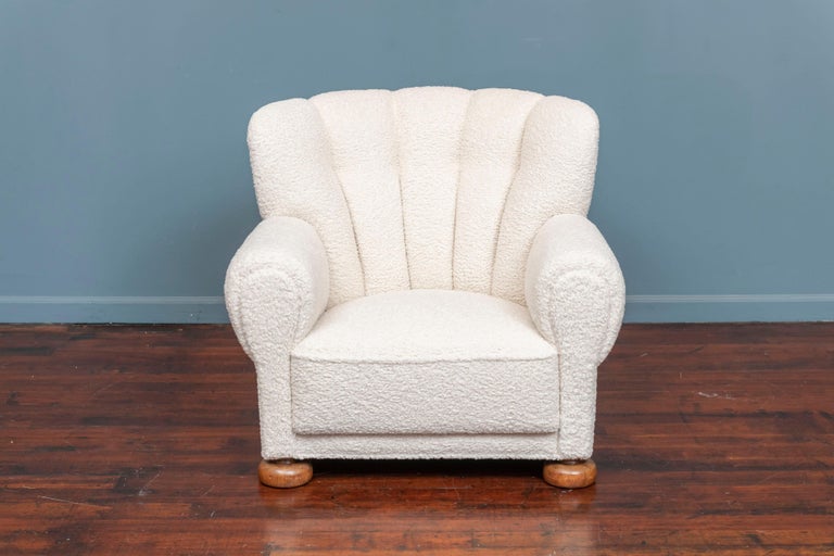 Scandinavian lounge chair or club chair from the 1930's, Denmark. The chair has been completely gone through and strengthened, refinished and newly upholstered in a faux sheepskin fabric. It is very inviting and comfortable, ready to be installed