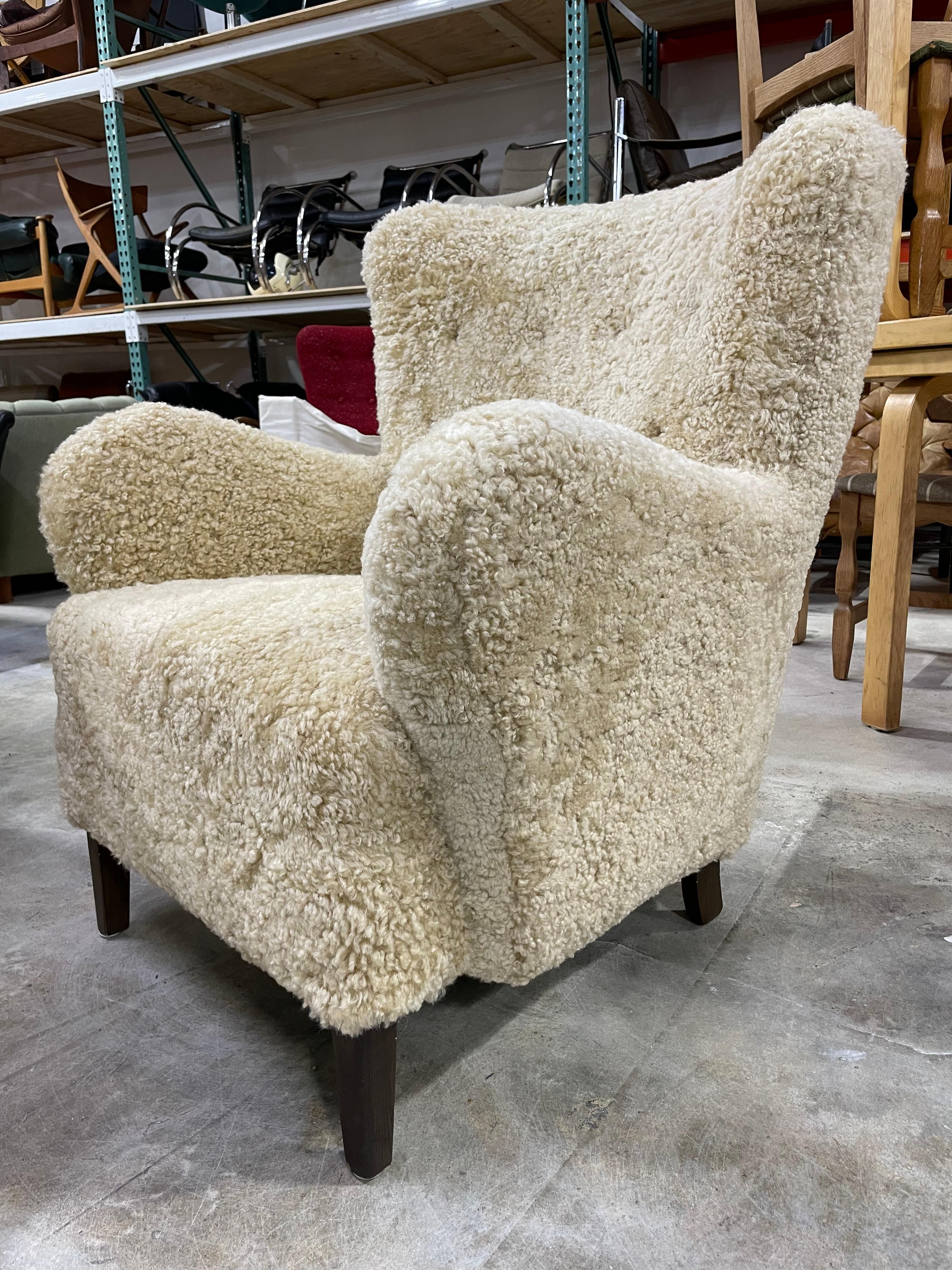 Super comfortable Danish Lounge Chair. Honey toned sheepskin. Highback. Recently upholsterered. 