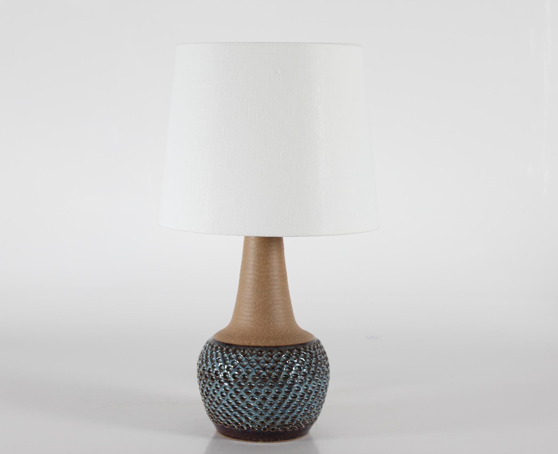 Mid-century tall budded table lamp model no. 3055 designed by Einar Johansen for Danish stoneware manufacturer Søholm. Produced, circa 1960s.

The lamp has been left unglazed on the neck and shoulder which is contrasted by a textured surface and
