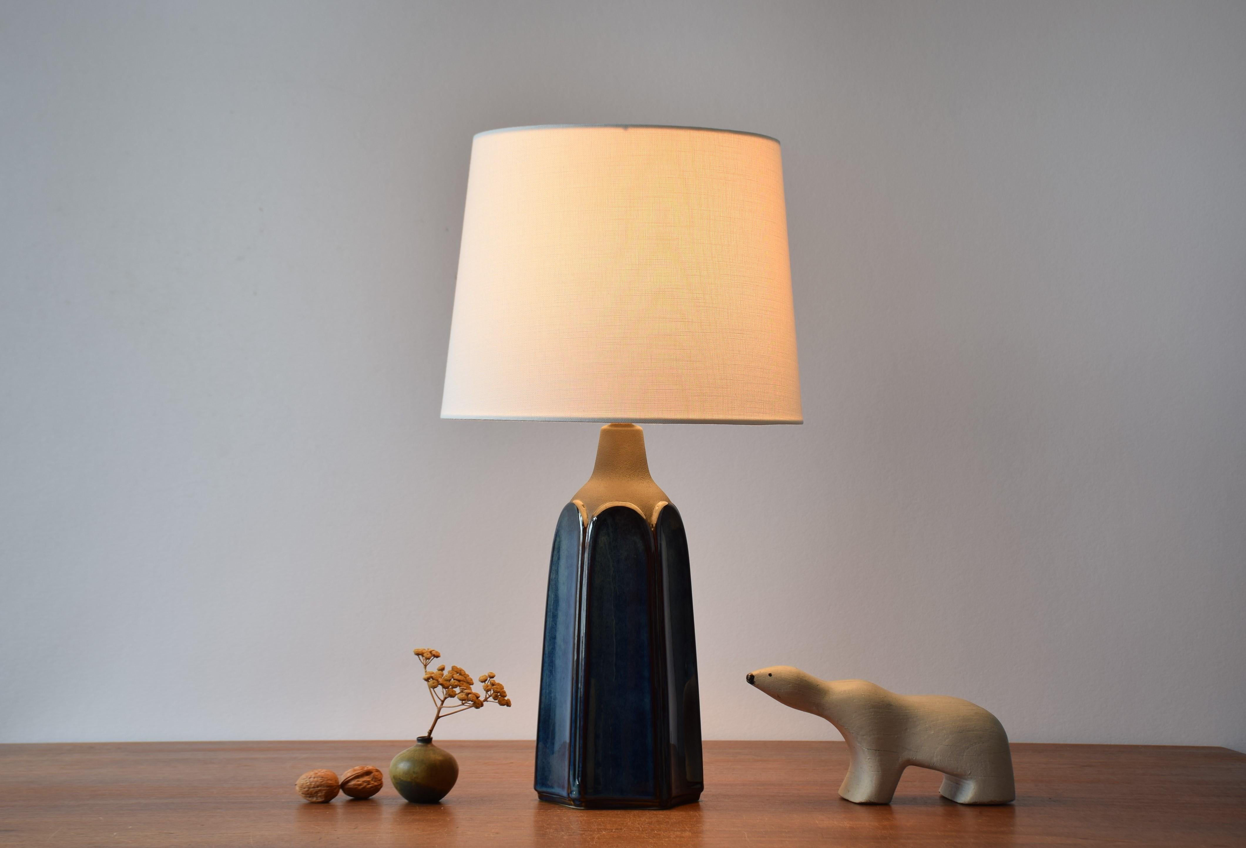 Sculptural table lamp by Einar Johansen for Søholm Stentøj, Denmark, circa 1960s.
The sculptural shape and the shiny blue glaze with brown elements gives the lamp a very vivid expression.

Included is a new lamp shade designed and made in