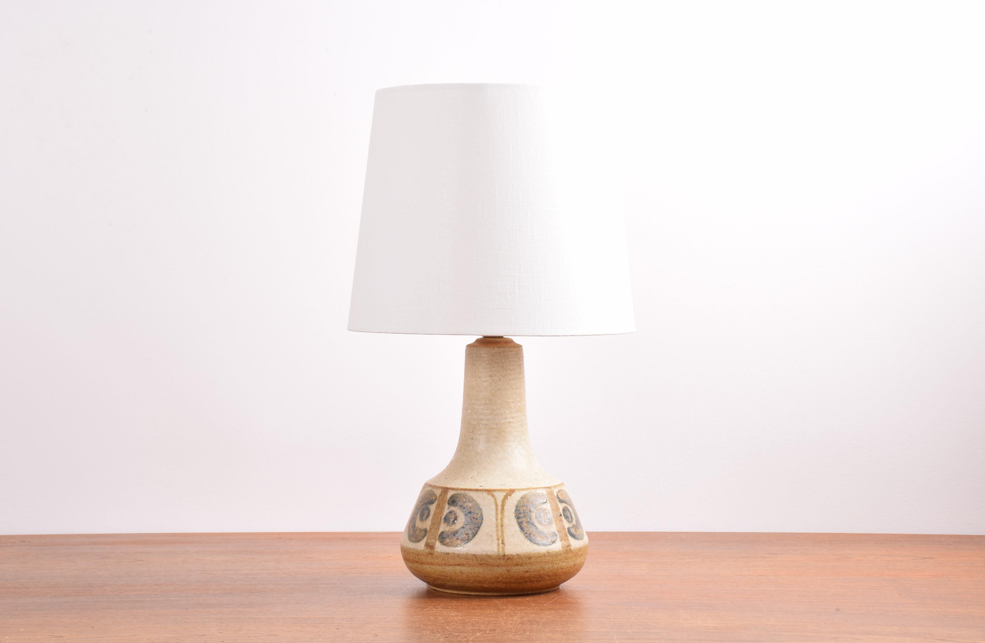 Midcentury Danish table lamp from Søholm Stentøj, Denmark designed by Svend Aage Jensen. Made circa 1960s to 70s.

The lamp is handmade and made from stoneware. It has a repeated handpainted stylised flower decor in eathy tones.

Included is a