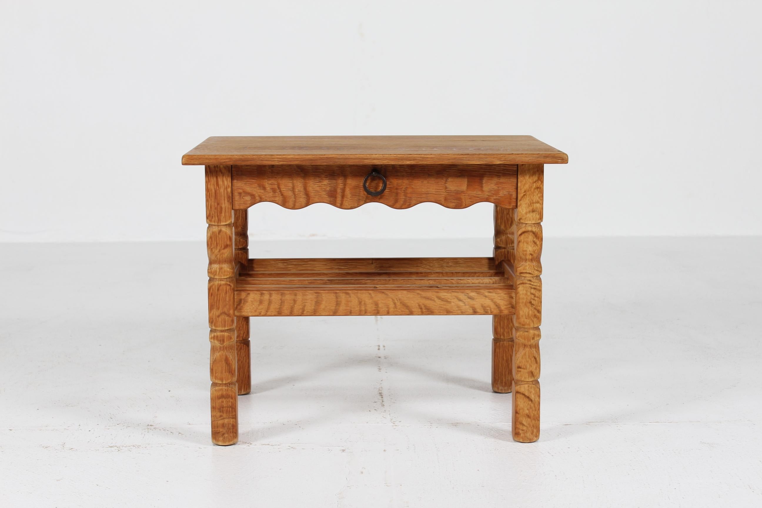 Danish side table and bedside table with drawer made of oak with handles of iron.

Made by a Danish Furniture Factory in the 1970s, most likely EG Møbler

The fine natural surface and patina with a warm glow has slowly been added after years of
