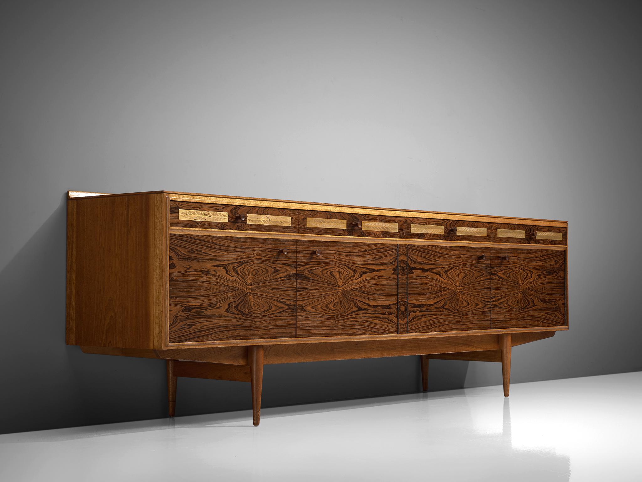 Sideboard, rosewood and walnut, Denmark, 1950s.

This sideboard is well-constructed and detailed in a discrete manner. Produced in rosewood and walnut. The piece shows well-designed lines and interesting details, such as brass strips with