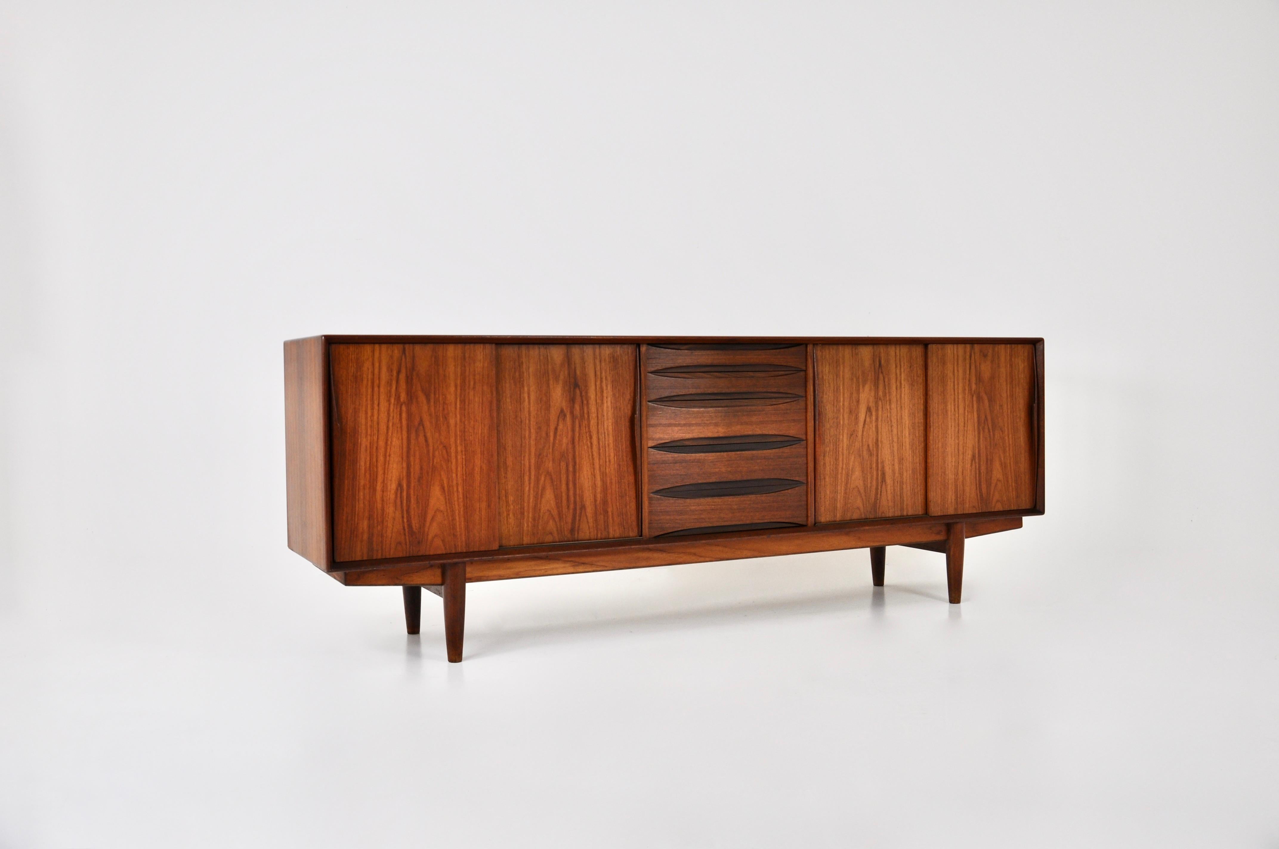 Danish sideboard in wood with 4 drawers and 4 sliding doors containing shelves. Stamped on the inside. Wear due to time and age.