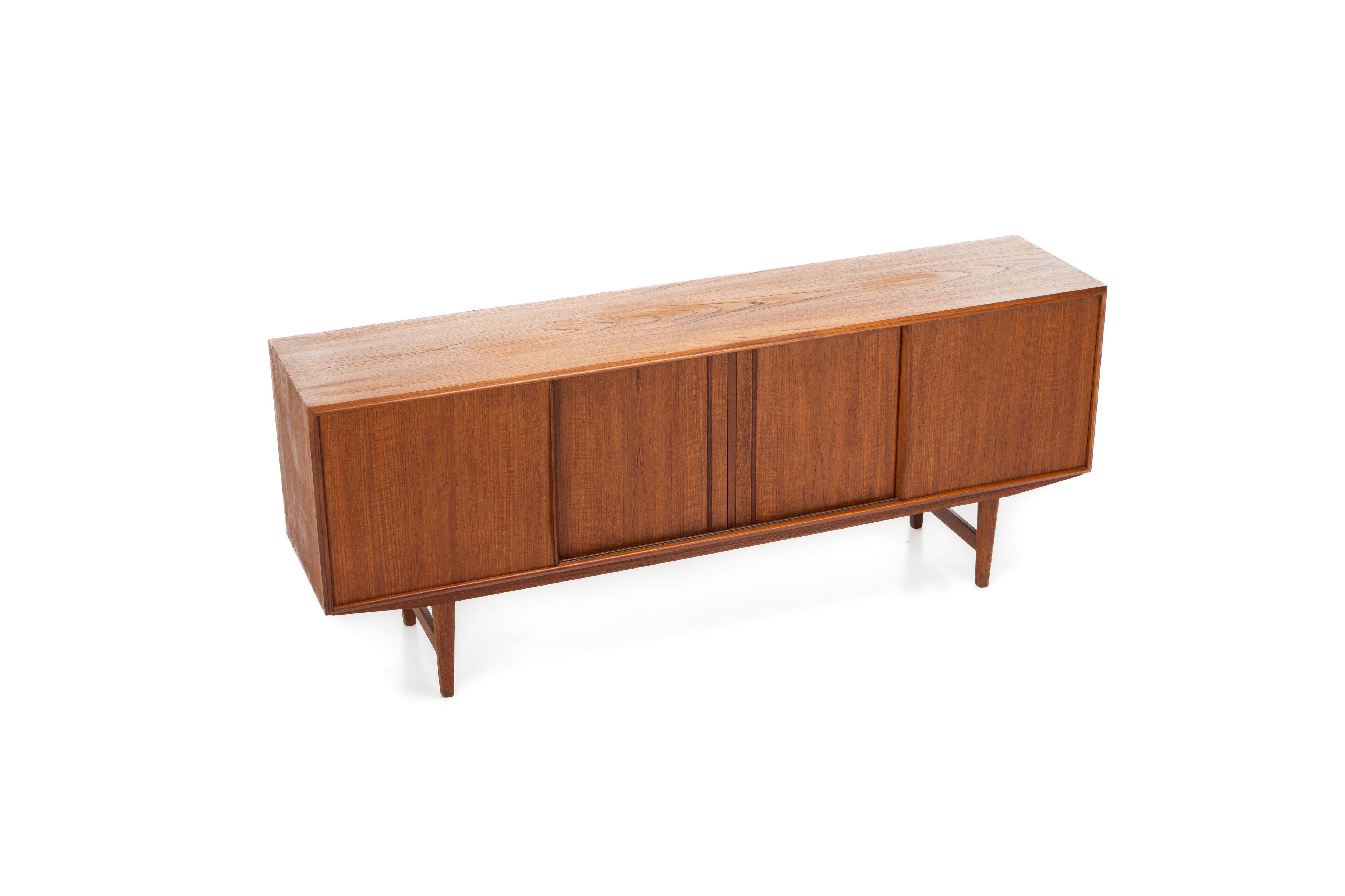 Beautiful Danish sideboard in teak designed by EW Bach for Sejling Skabe in the 60s. There are four sliding doors and lots of storage space.
 