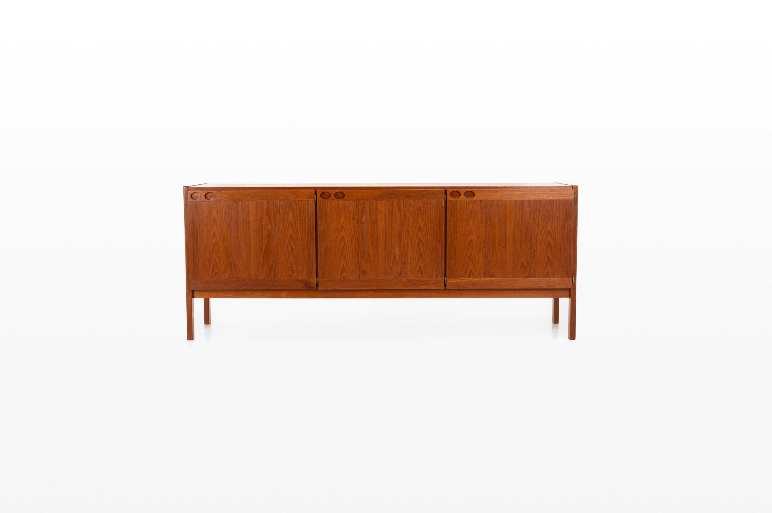 Vintage sideboard in teak designed by Ib Kofod Larsen and produced by Faarup Møbelfabrik in Denmark in the 1960s. The sideboard has three doors, three inner drawers and plenty of storage space. The sticker of the producer is still present.
 