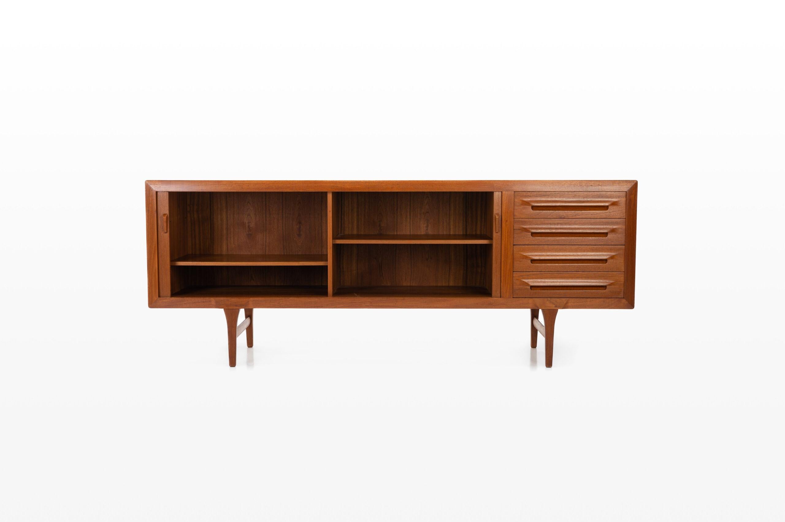 Stylish teak sideboard with tambour doors, four drawers and plenty of storage space. Designed by Ib Kofod Larsen for Faarup in the 1960s. The back is also finished in teak. This sideboard is a real eye-catcher.

Dimensions:
W: 220 cm
D: 52