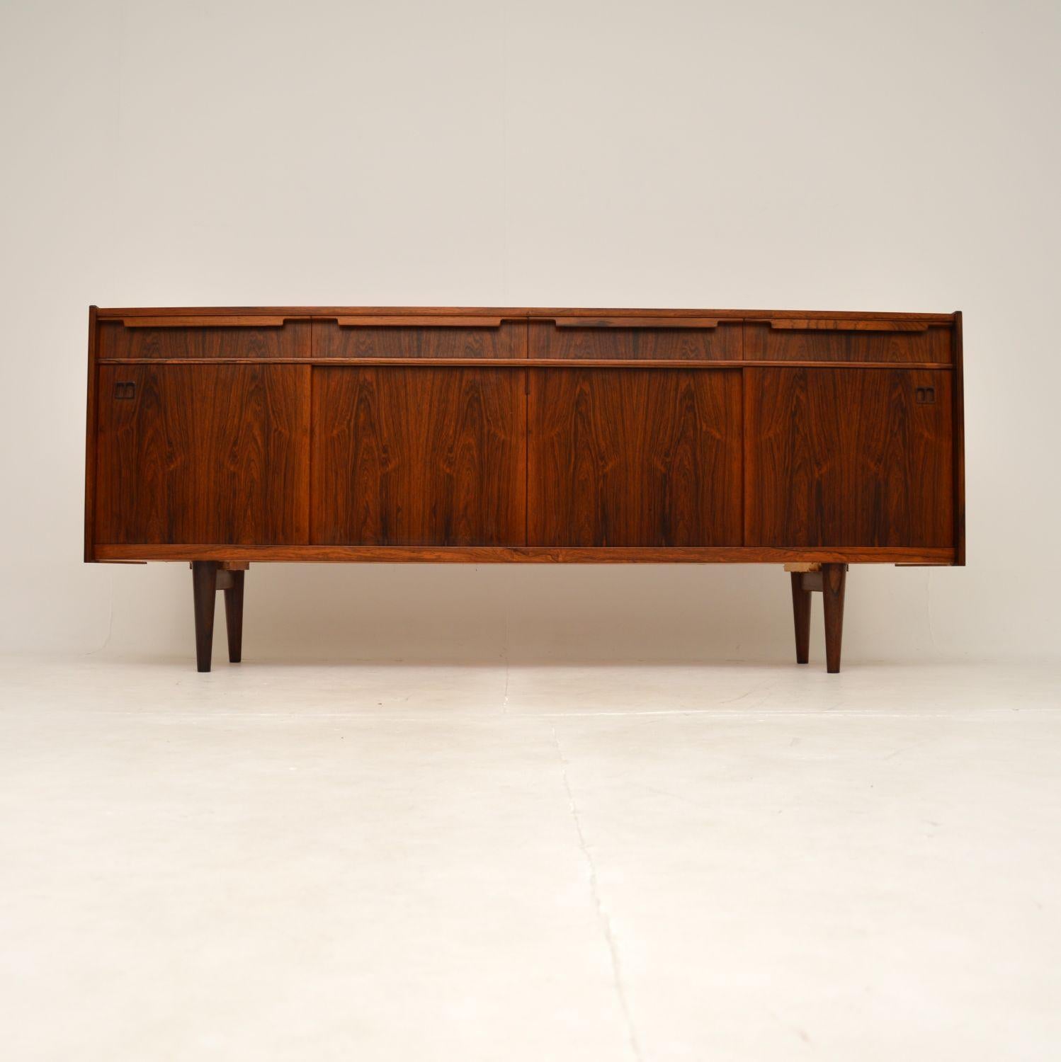 A stunning and extremely rare Danish sideboard by Johannes Andersen for Bernhard Pedersen. This was made in Denmark, it dates from the 1960’s.

The quality is outstanding, this is beautifully designed and looks amazing from all angles. The top