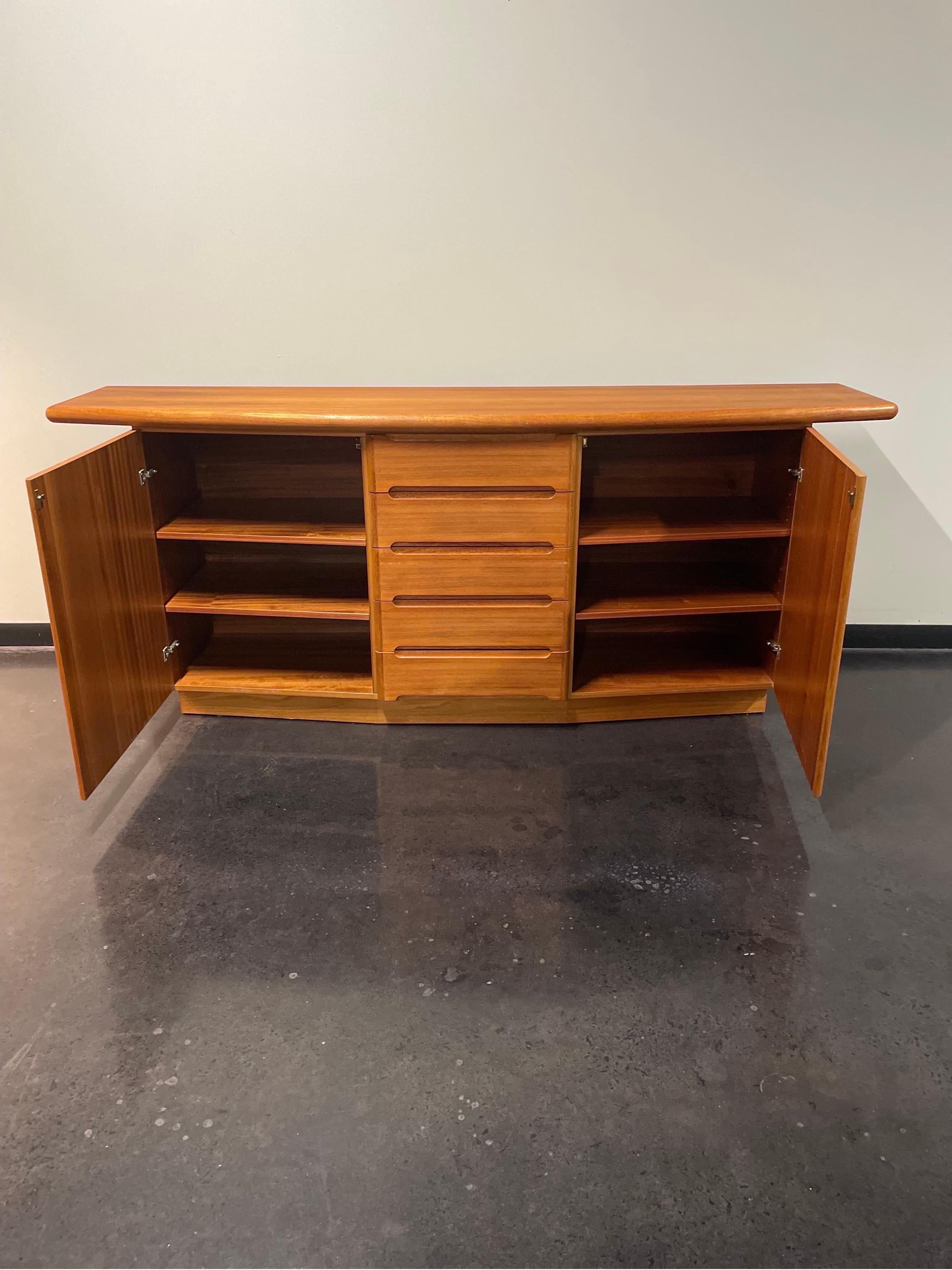Danish modern sideboard/credenza by Skovby made out of teak wood and featuring 5 drawers and 2 storage areas.