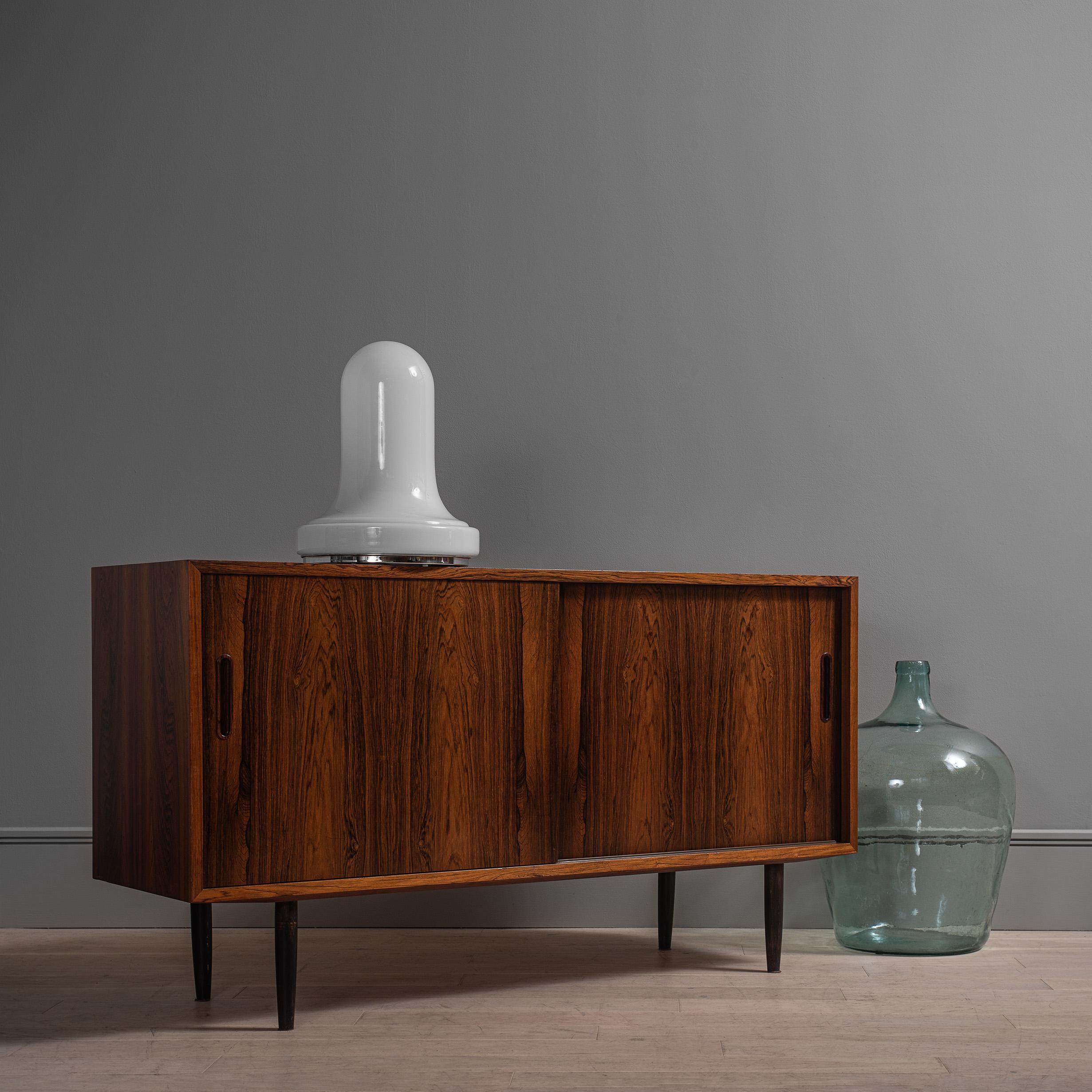 A beautifully sleek and practical credenza design from Poul Hundevad circa 1960. Height adjustable inner shelves and one small internal drawer.
