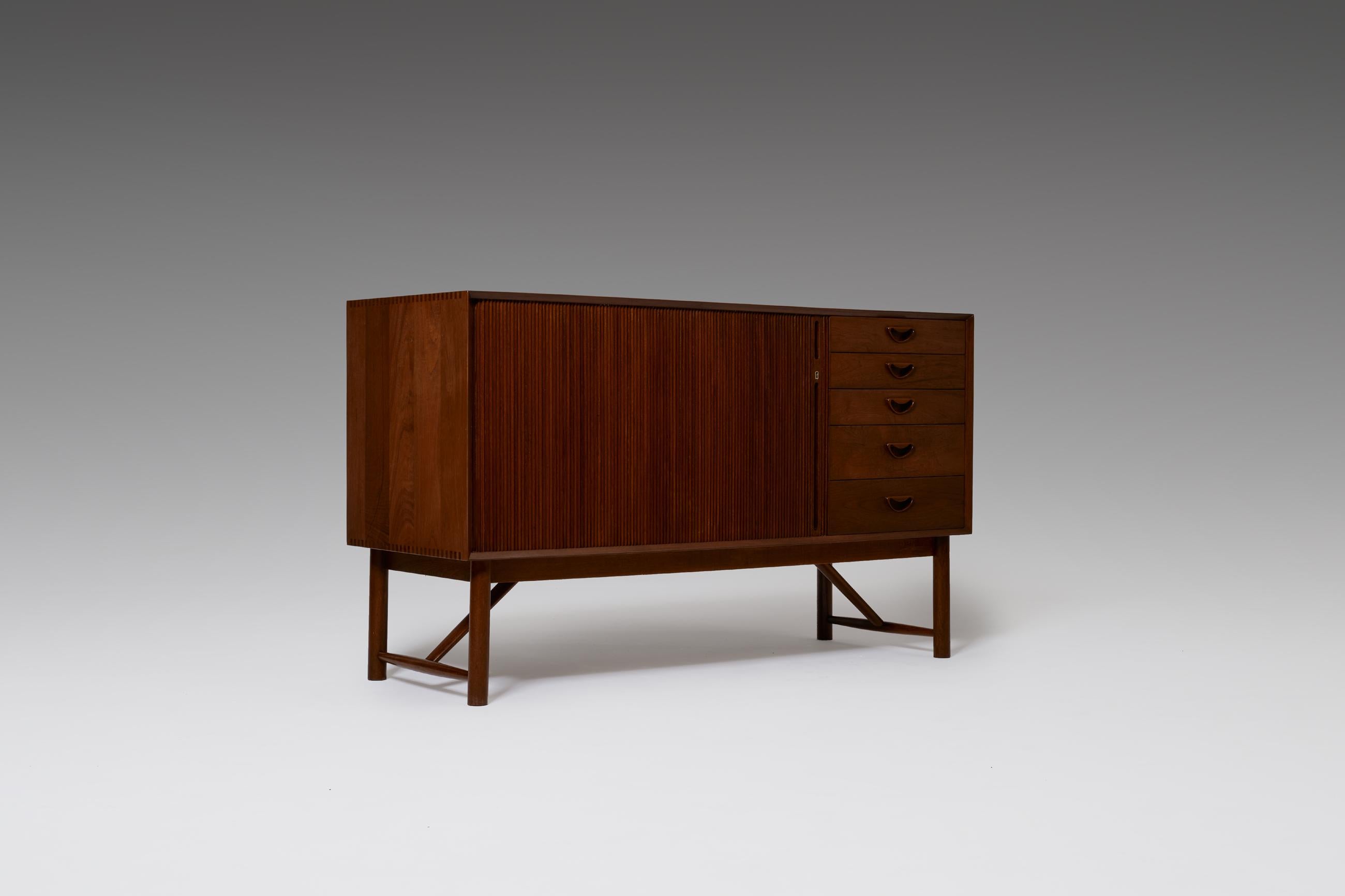 Scandinavian Modern credenza by Peter Hvidt and Orla Mølgaard-Nielsen for Søborg, Denmark, 1960s. High quality production made from the finest solid teak with a beautiful natural warm grain. The cabinet shows many refined details such as the finger