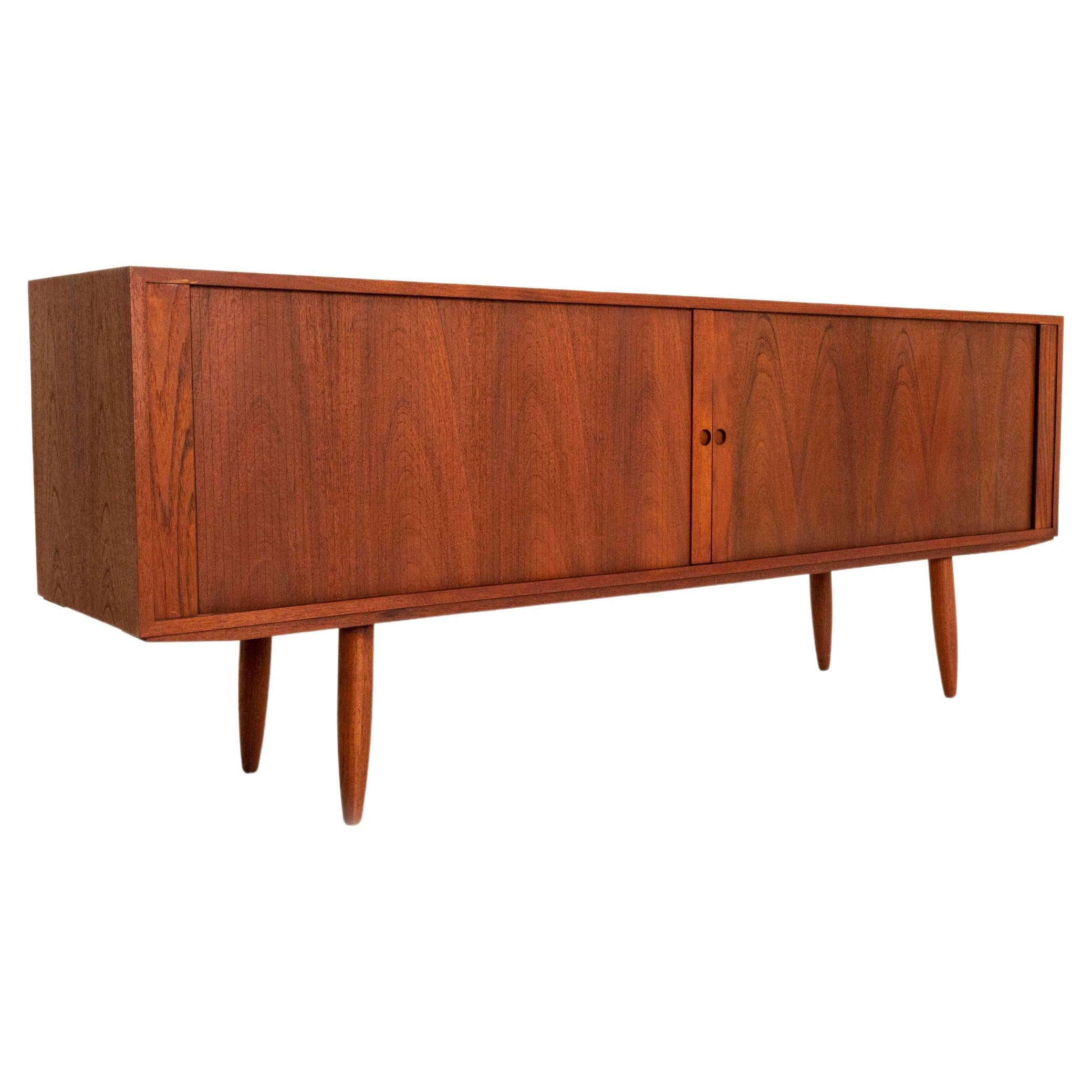Impressive Danish sideboard in teak by Bruno Hansen. This Sideboard has tambour doors with four colored drawers. Although, fully in the style of the Danish sideboards in the 1960s; this sideboard is probably manufactured in the 2000s. In very good