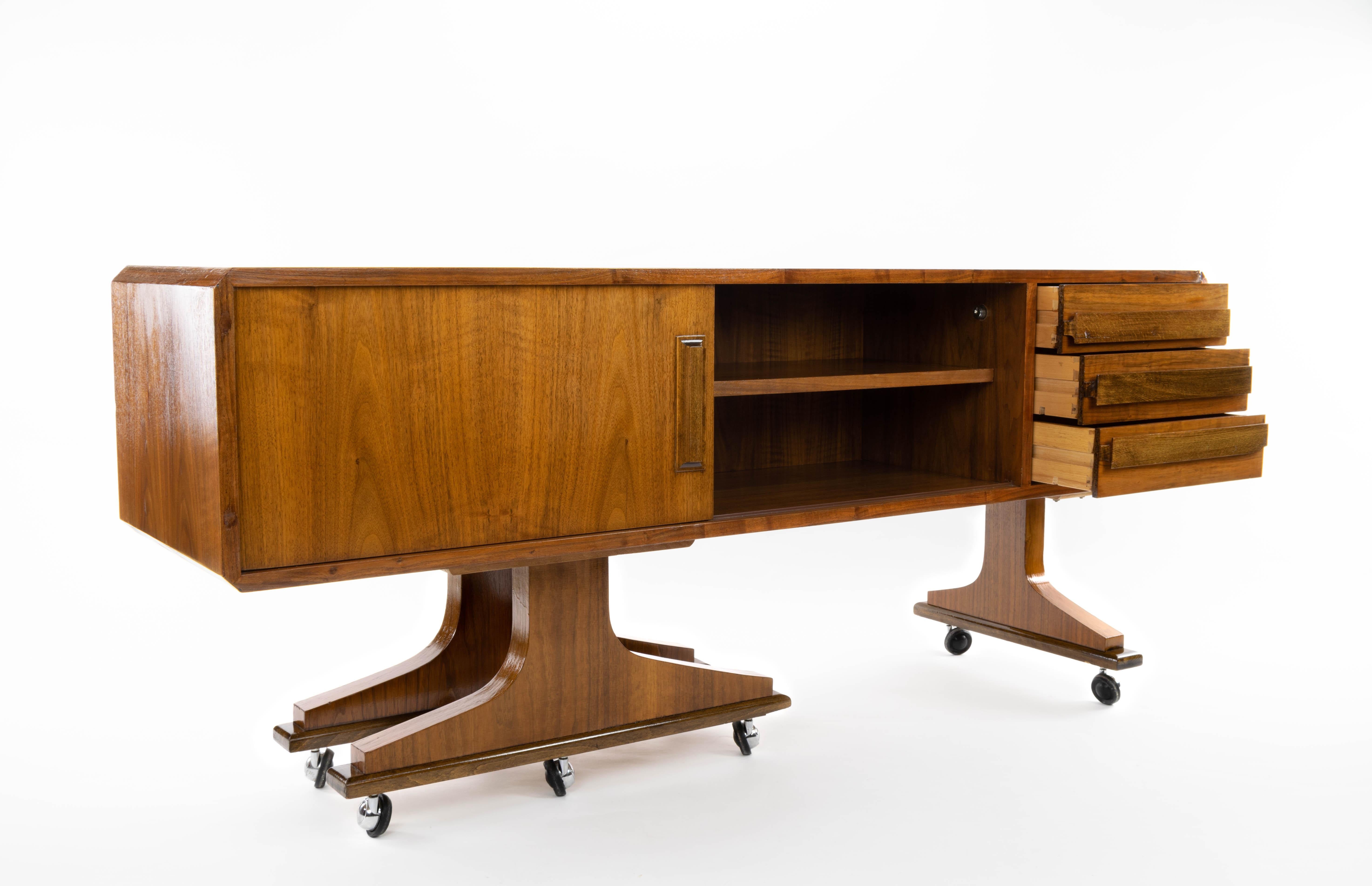 Versatile and practical Danish sideboard Mid-Century Modern double sided and laminated oak wheels, in the style of Clausen & Søn.
On one side it has a storage area and three drawers and on the other side it has a sliding door with a storage