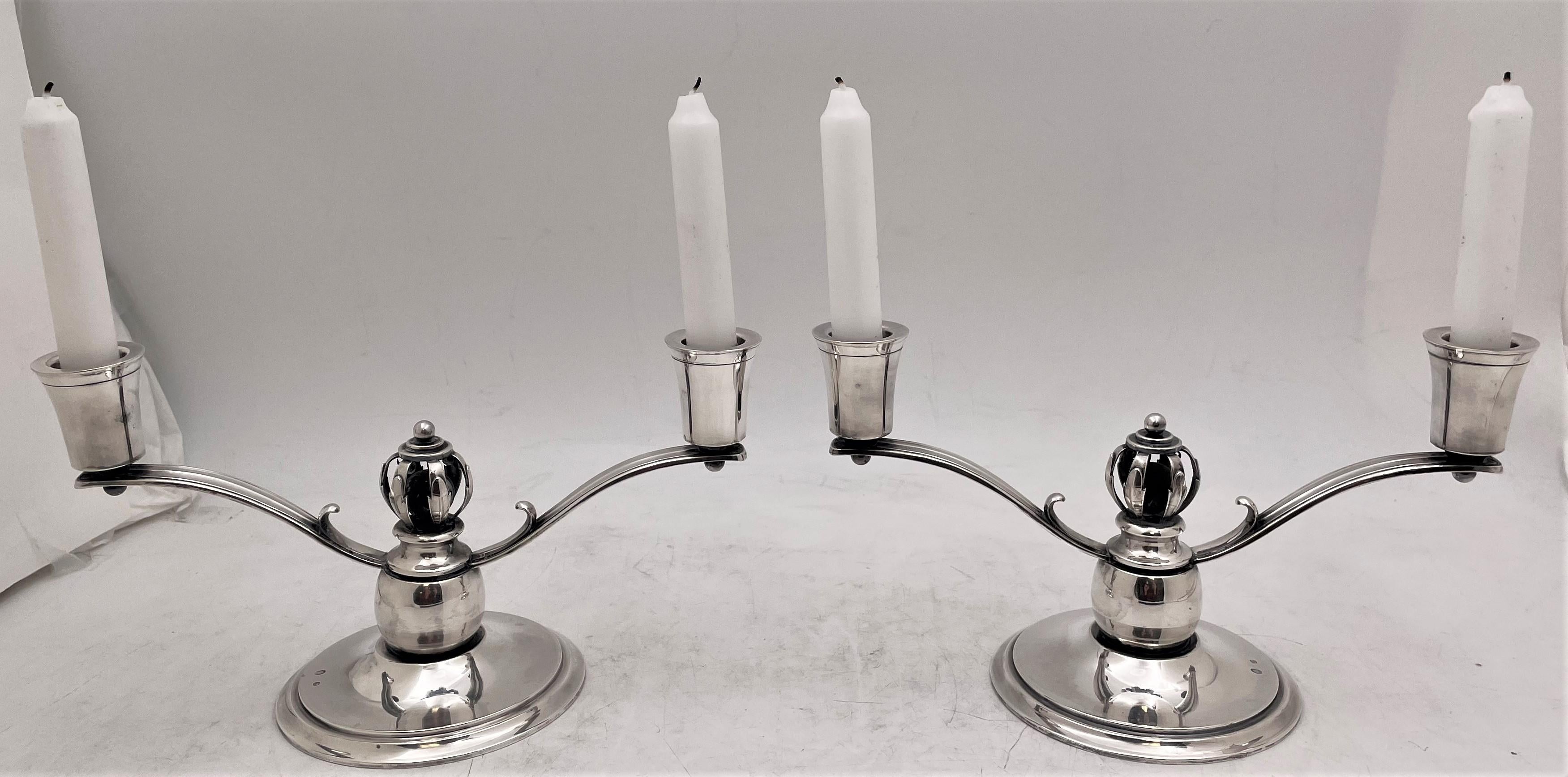Danish silver 2-light candelabra or oil lamps in Georg Jensen, Mid-Century Modern style with an elegant, geometrically inclined style. Each measures 10 1/4'' in length by 4 1/2'' in depth by 5 1/2'' in height. Total weight is 24 troy ounces.