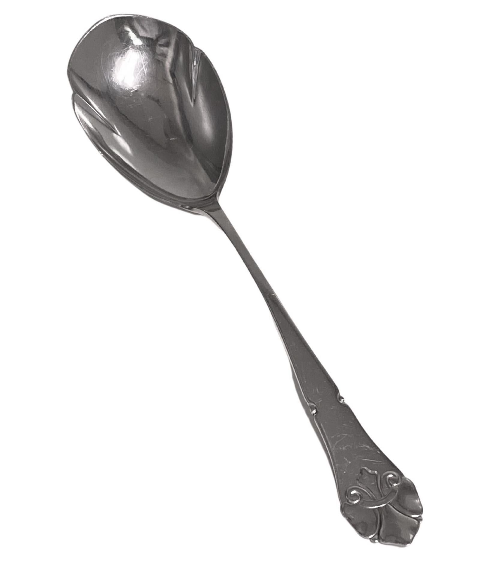 Danish Silver Arts Crafts Nouveau style Serving Spoon 1925. Stylised handle with tulip shape bow. Danish silver marks the 3 towers and 25 indicating it was made in 1925 and has the Assay master’s mark of Christian F Heise. Length: 9 7/8 inches.