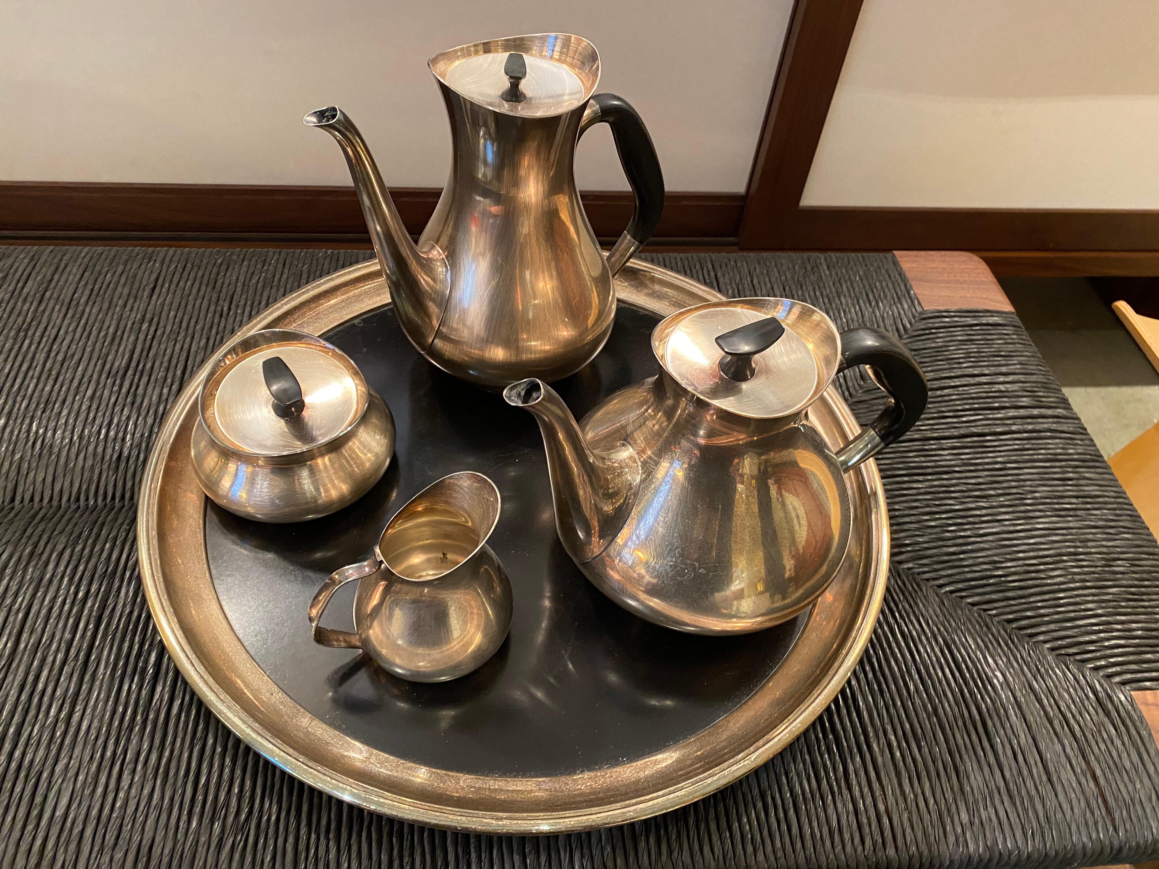 Mid-Century Modern silver plated 4-piece tea and coffee set including elegant round tray, designed by Hans Bunde for Cohr, circa 1960s, Denmark. The lids have a special fitting so they never fall when pouring.