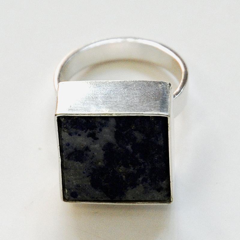 A square shaped silver ring with the Afghanistan Lapis Lazuli blue square stone on top embraced by a solid silver band edge holding the stone. Designed and made by Brødrene Bjerring (brothers Bjerring) in the 1970s Denmark. Signed Brdr Bje