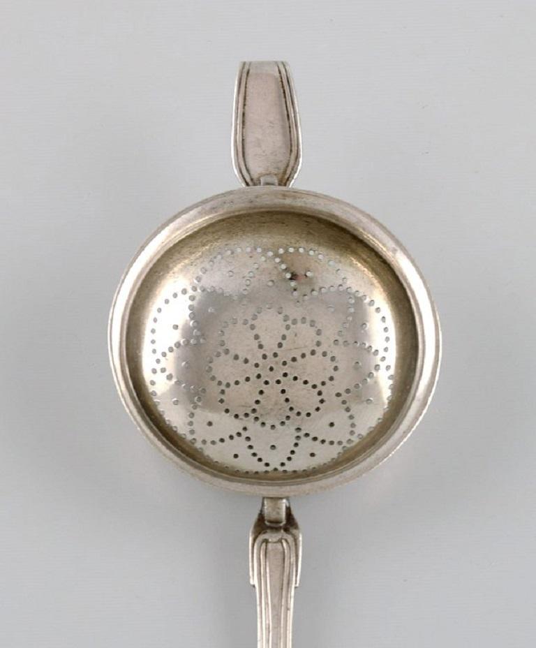 Danish silversmith. Antique silver 830 tea strainer. 
Dated 1874.
Length: 18 cm.
In excellent condition.
Stamped.
Large private collection of European silver tea strainers.