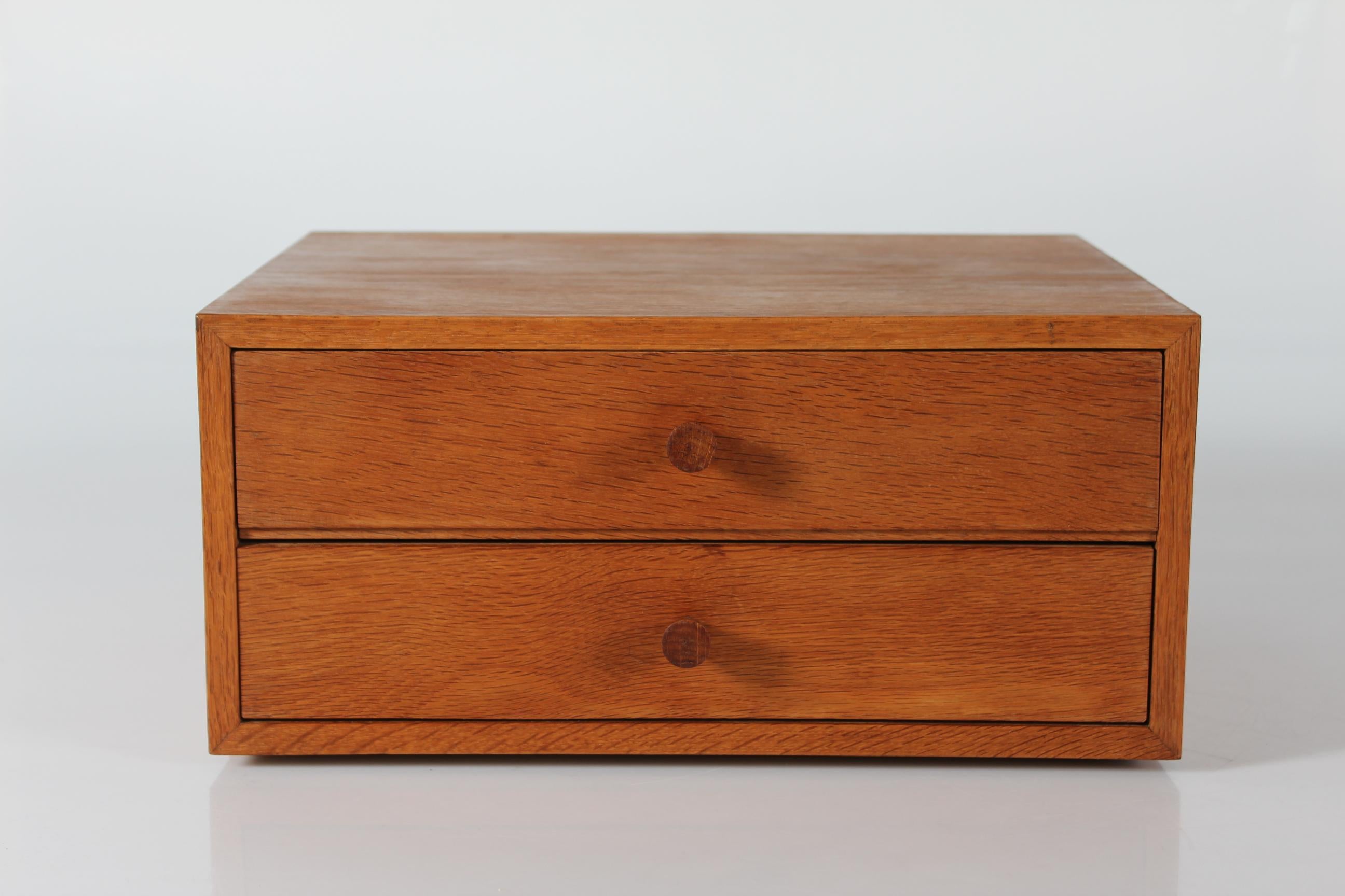 Mid-century Scandinavian small chest of drawers made from oak with a beautiful warm patina. It’s most like made in Denmark. Manufactured ca 1960s. 

The front of the drawers and the knobs are made from solid oak. The other visible surfaces are made